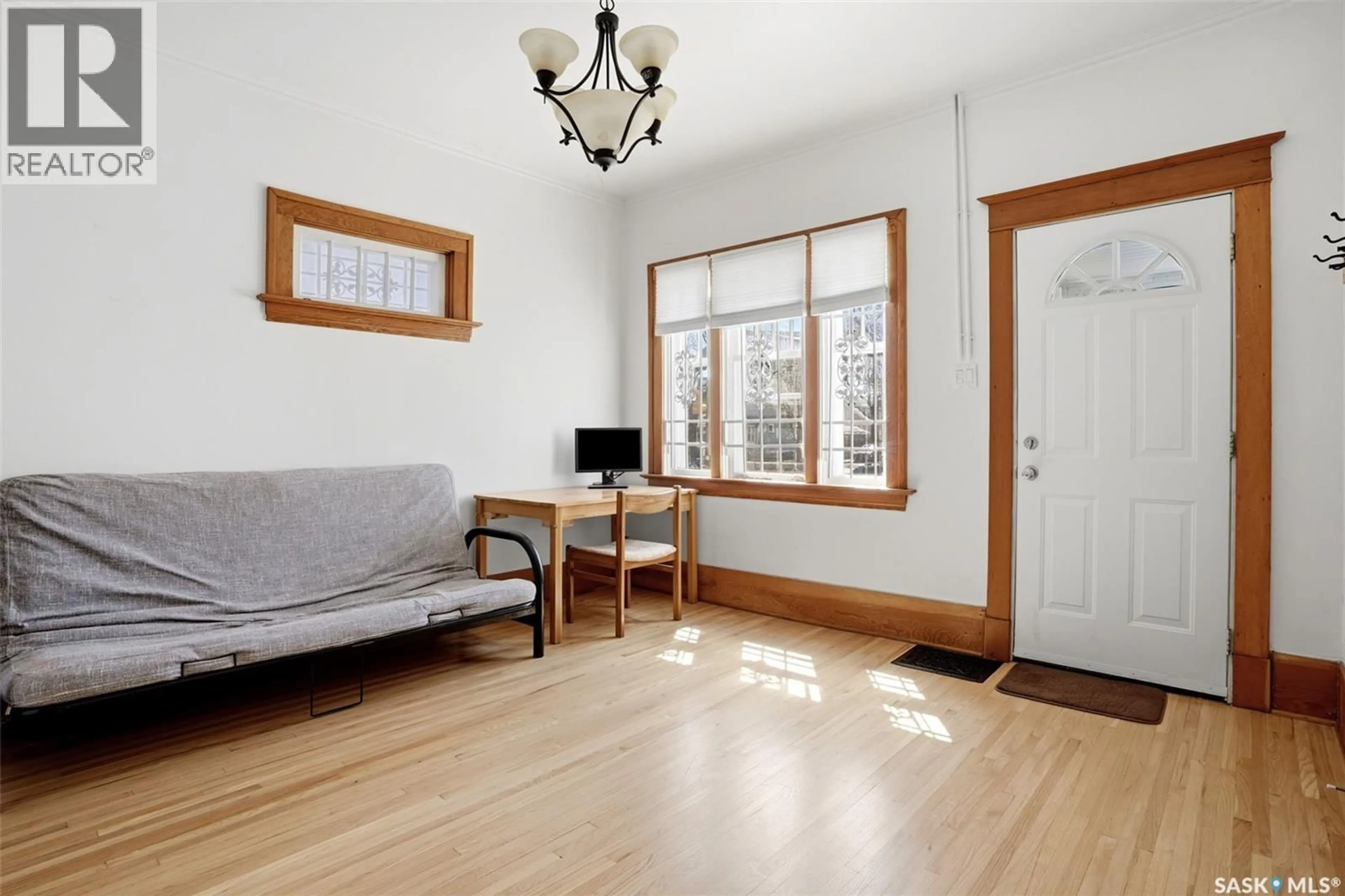 Living room with furniture, wood/laminate floor for 1206 VICTORIA AVENUE, Regina Saskatchewan S4P0N9