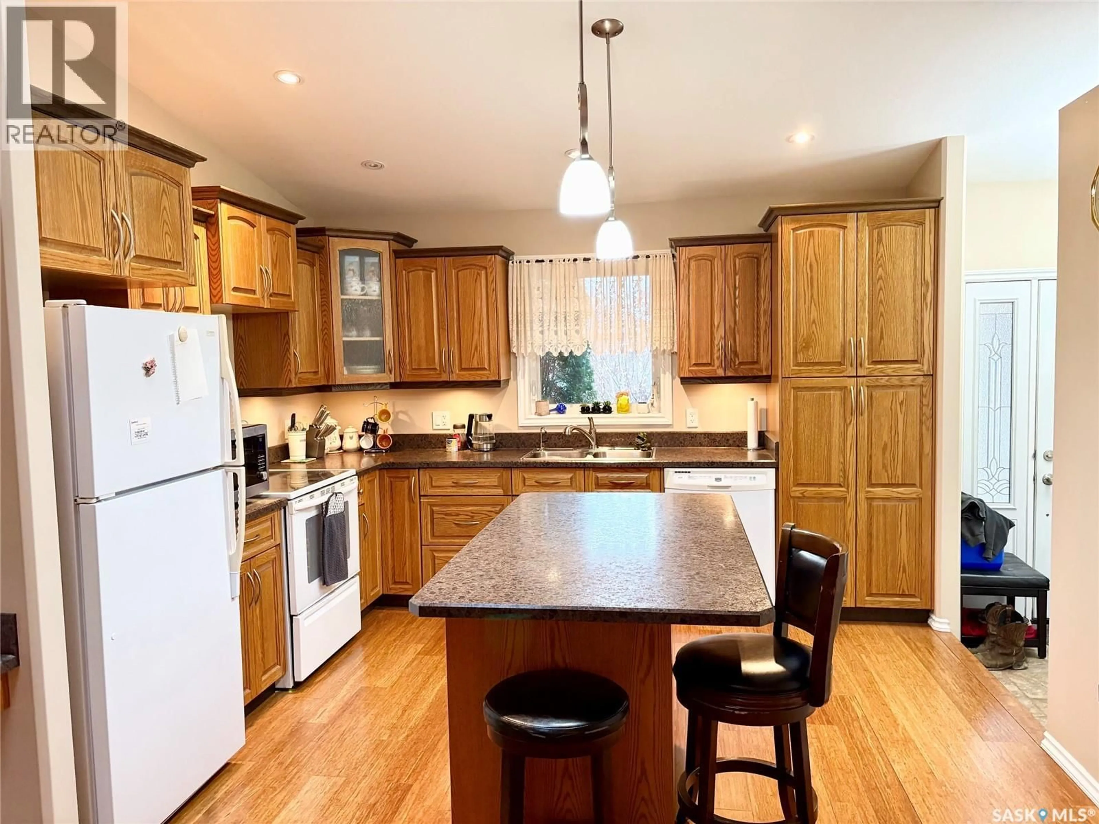 Open concept kitchen, wood/laminate floor for 109 GOOD SPIRIT CRESCENT, Yorkton Saskatchewan S3N3J8