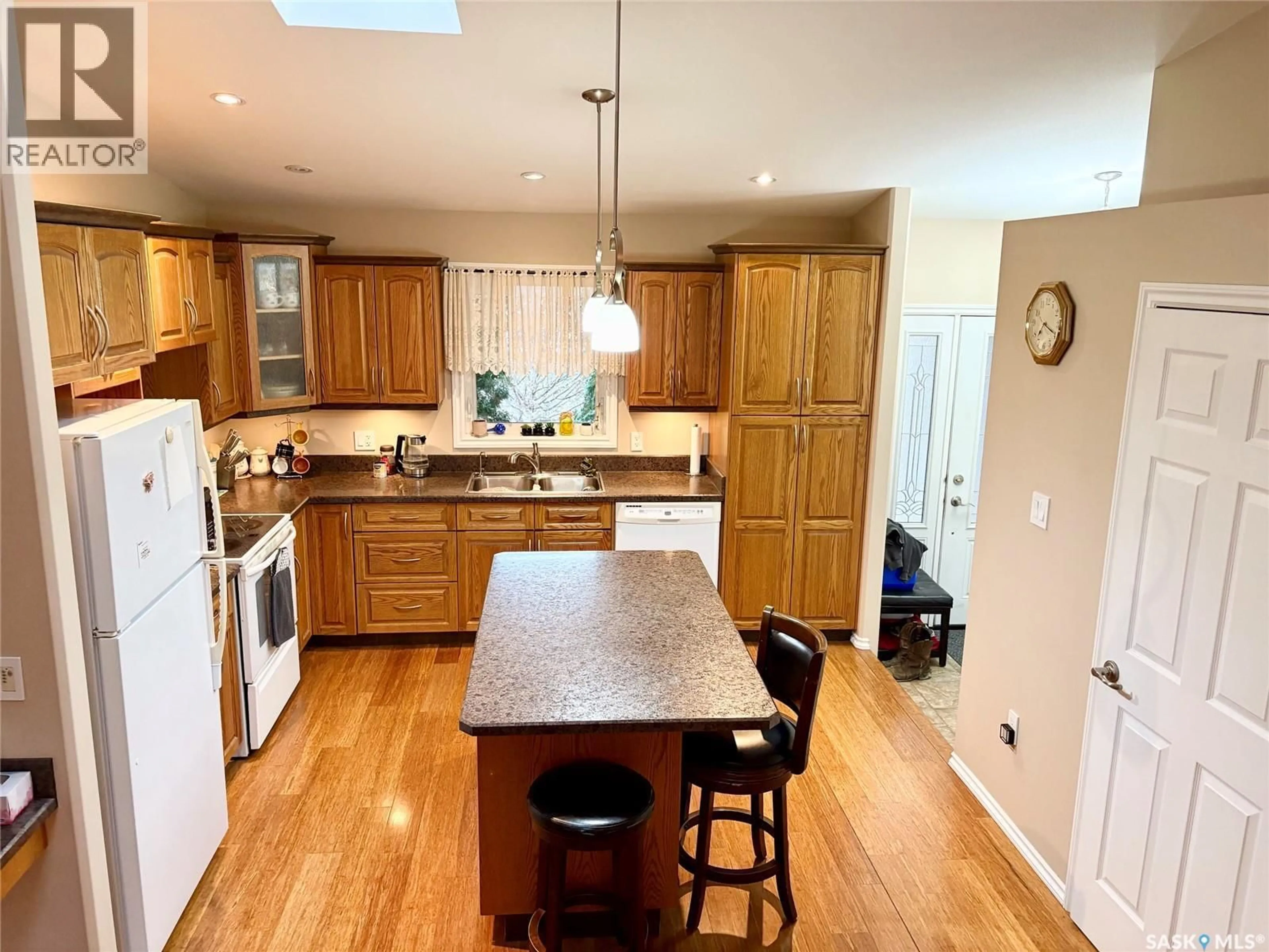 Open concept kitchen, wood/laminate floor for 109 GOOD SPIRIT CRESCENT, Yorkton Saskatchewan S3N3J8