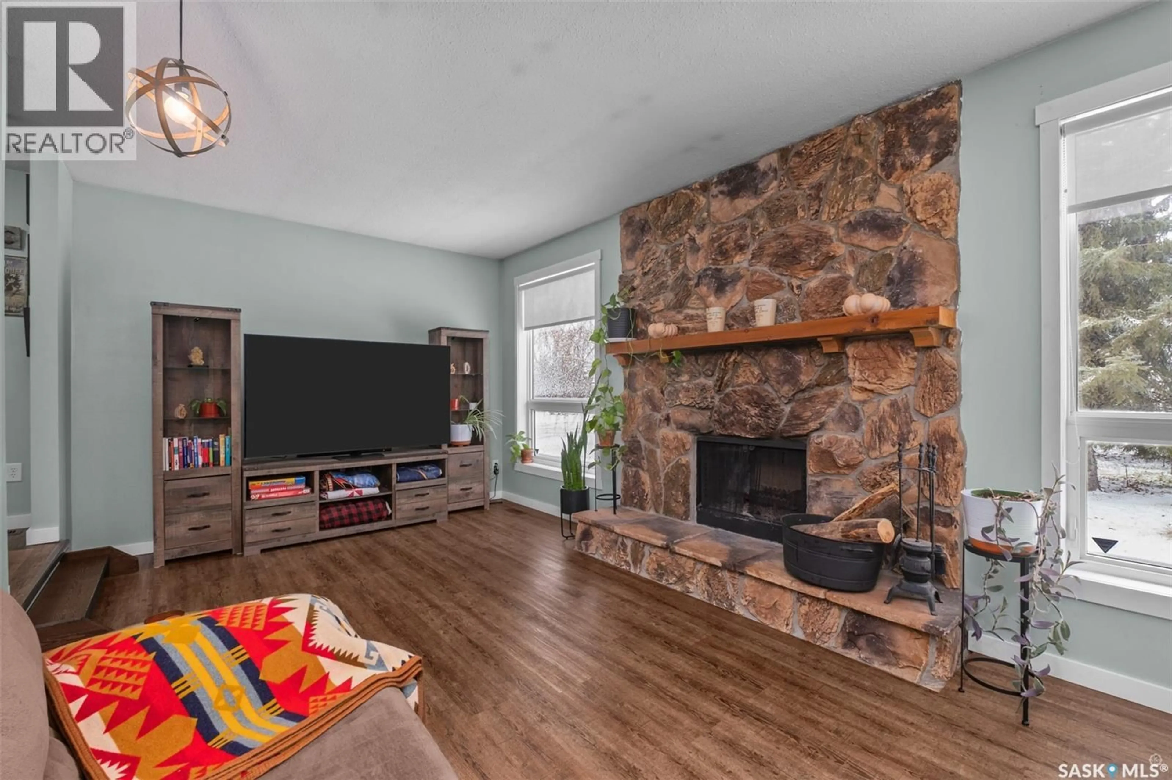 Living room with furniture, wood/laminate floor for NESBIT FOREST DRIVE, Garden River Rm No. 490 Saskatchewan S6V5R2