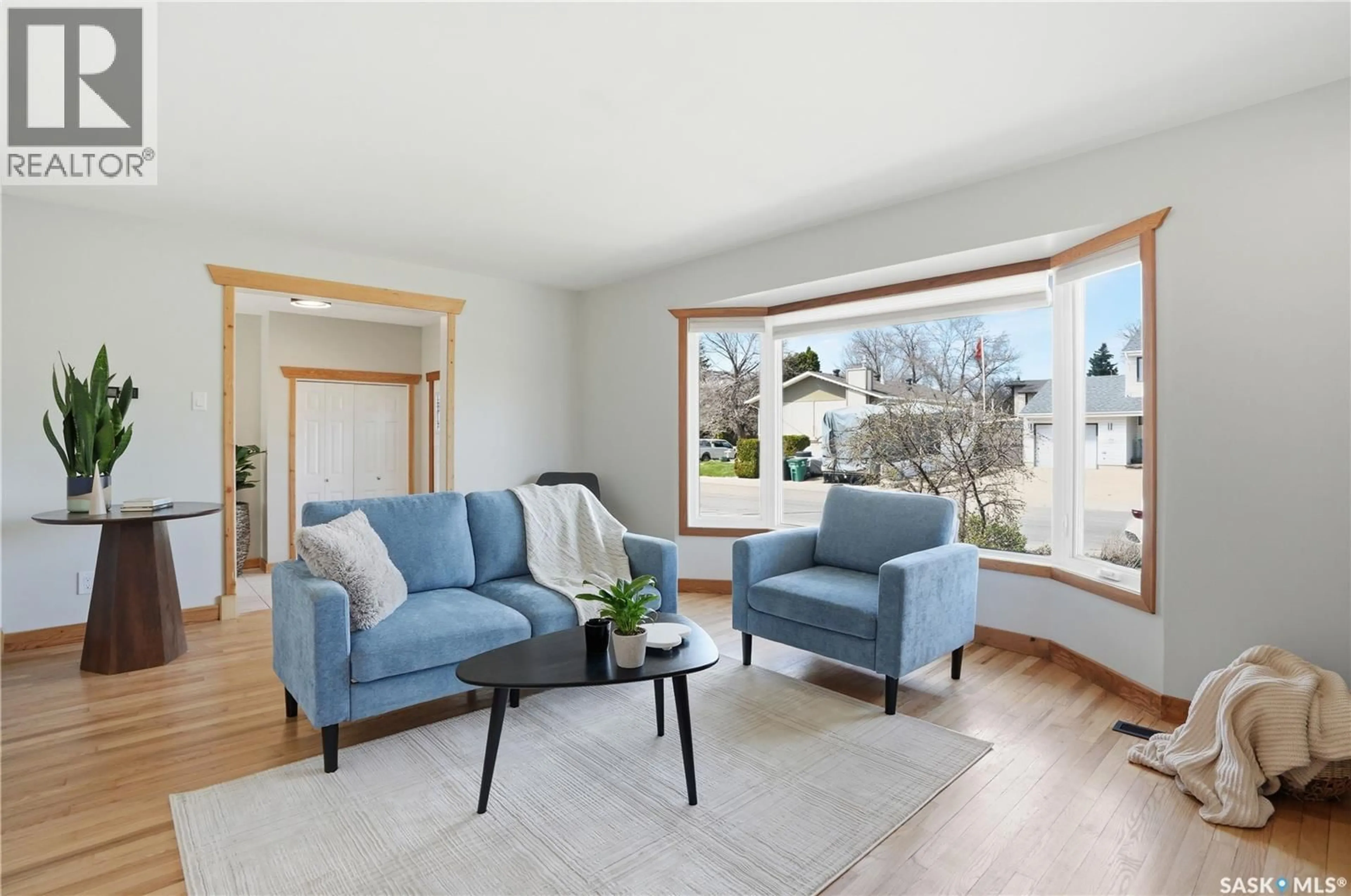 Living room with furniture, wood/laminate floor for 206 LA LOCHE TERRACE, Saskatoon Saskatchewan S7K4R9