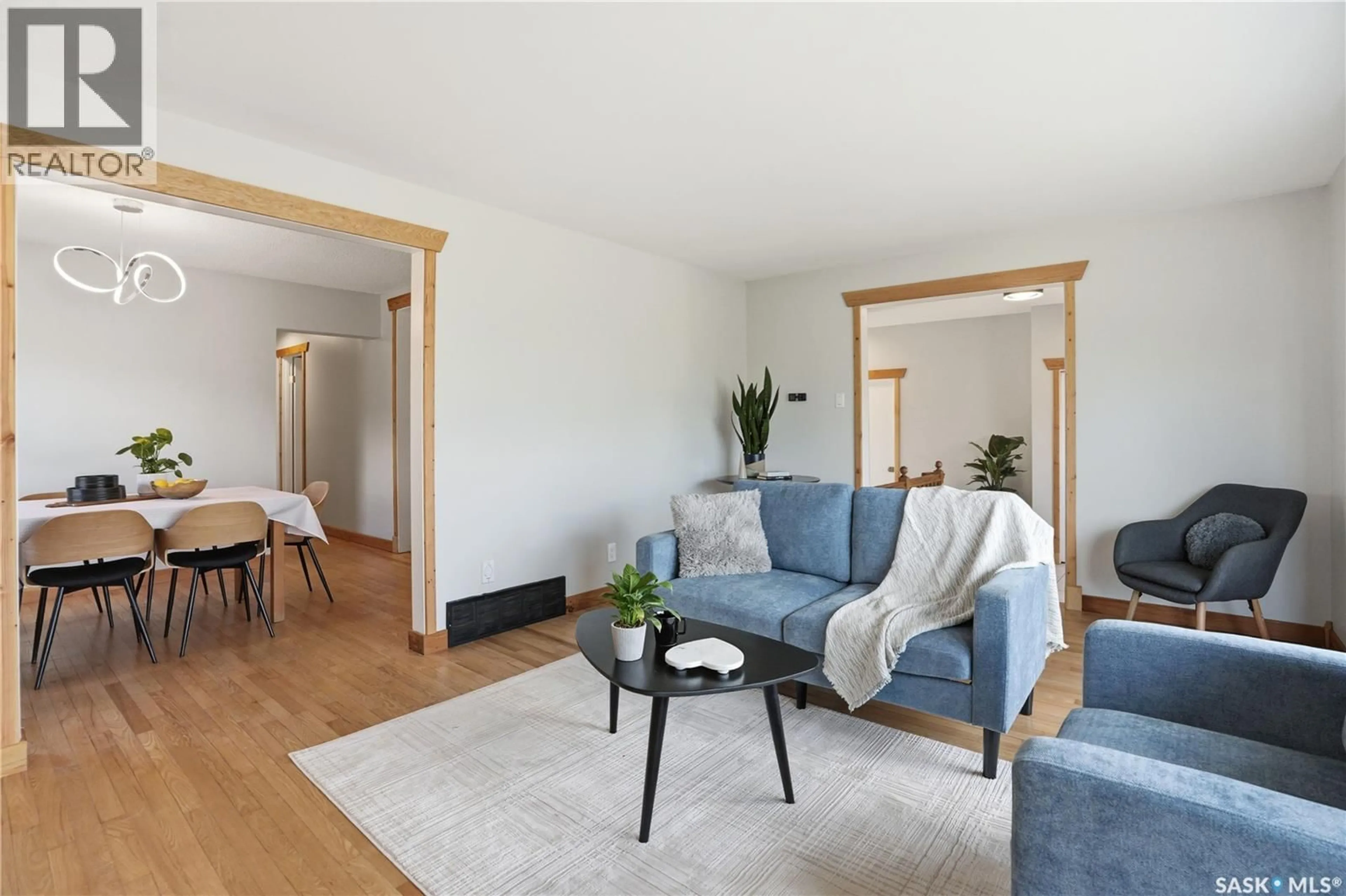Living room with furniture, wood/laminate floor for 206 LA LOCHE TERRACE, Saskatoon Saskatchewan S7K4R9