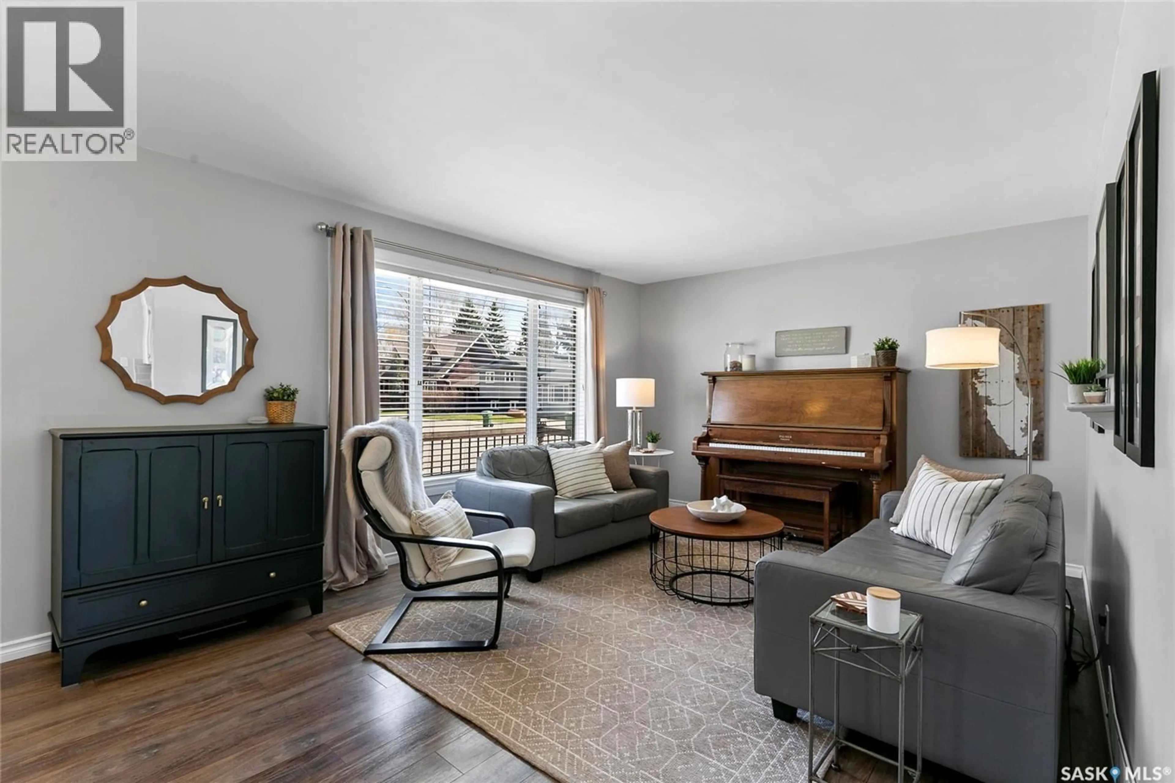 Living room with furniture, wood/laminate floor for 1206 FLEXMAN CRESCENT, Regina Saskatchewan S4X2Y8