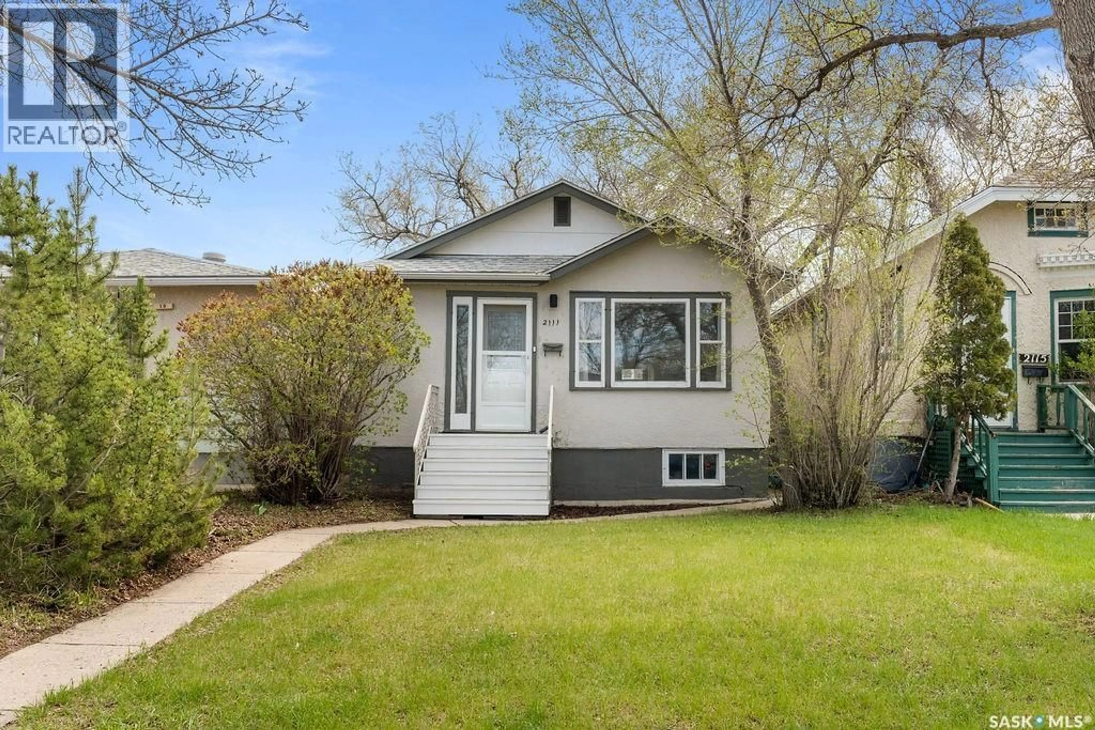 Home with vinyl exterior material, street for 2111 QUEEN STREET, Regina Saskatchewan S4T4C4