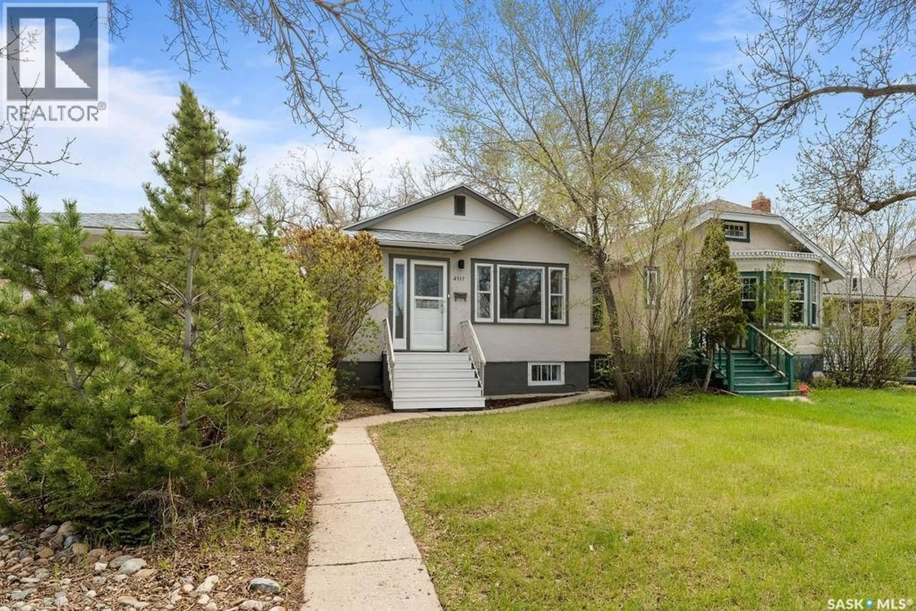 Home with vinyl exterior material, street for 2111 QUEEN STREET, Regina Saskatchewan S4T4C4