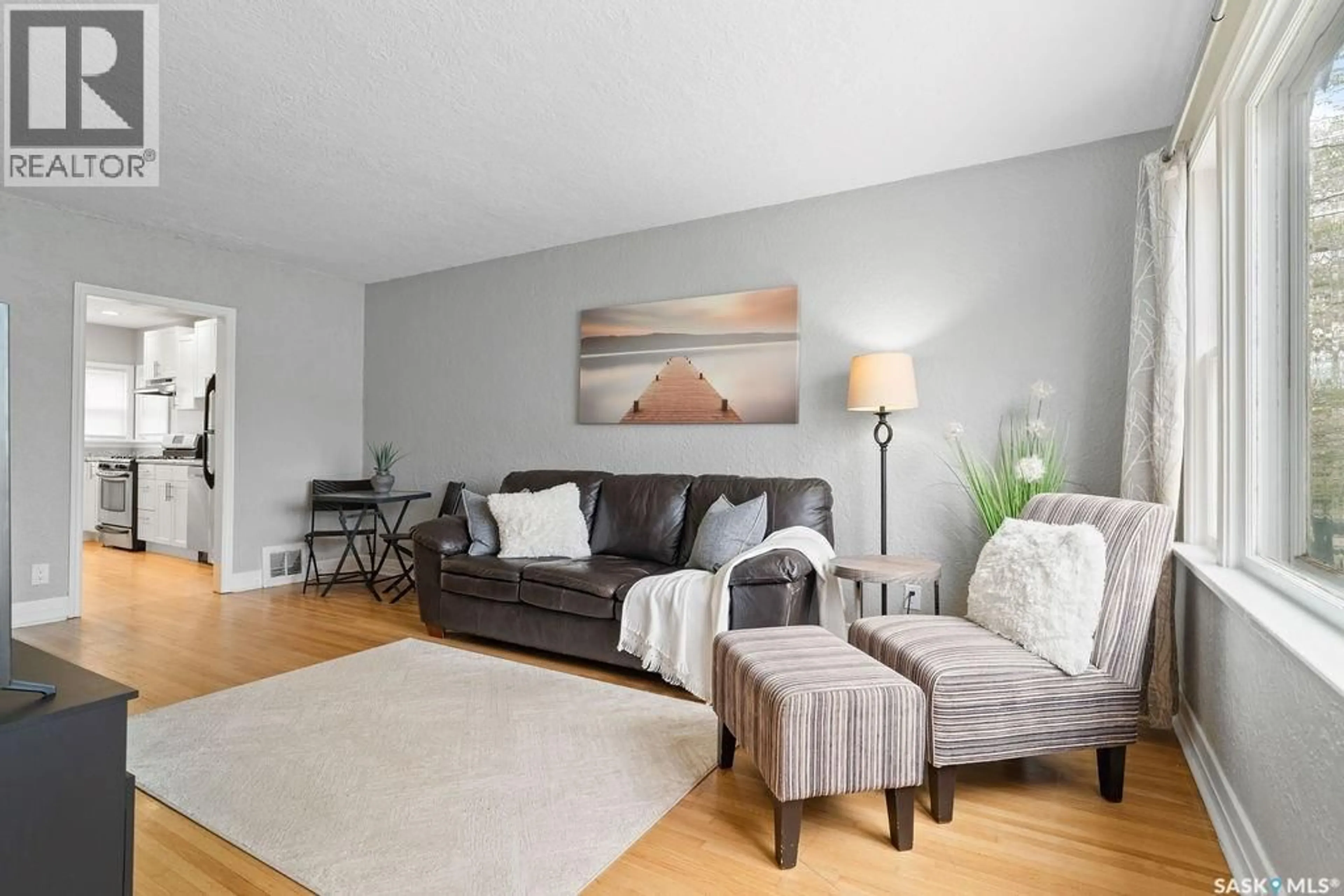 Living room with furniture, wood/laminate floor for 2111 QUEEN STREET, Regina Saskatchewan S4T4C4
