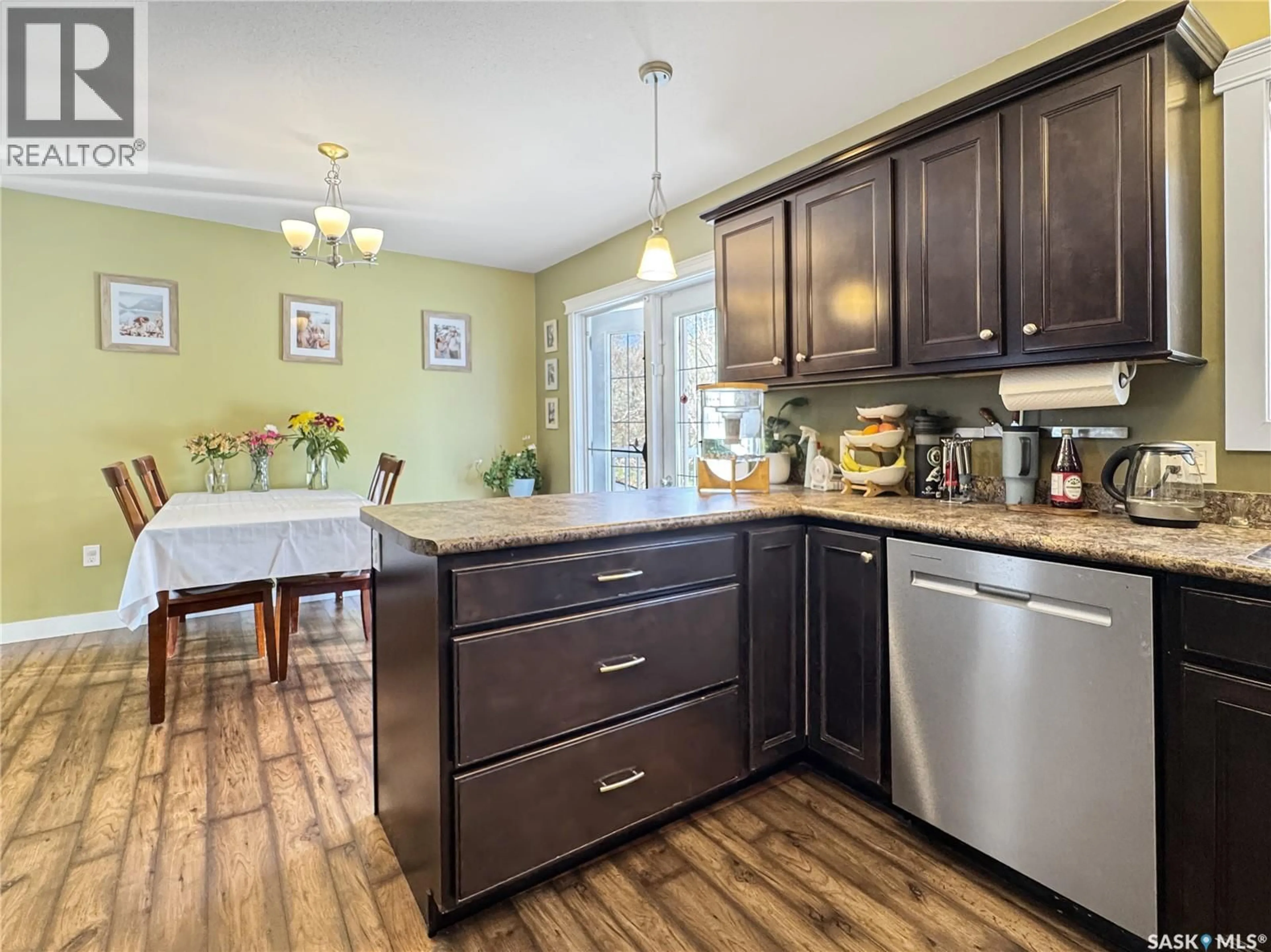 Open concept kitchen, wood/laminate floor for 1742 93RD STREET, North Battleford Saskatchewan S9A0C8
