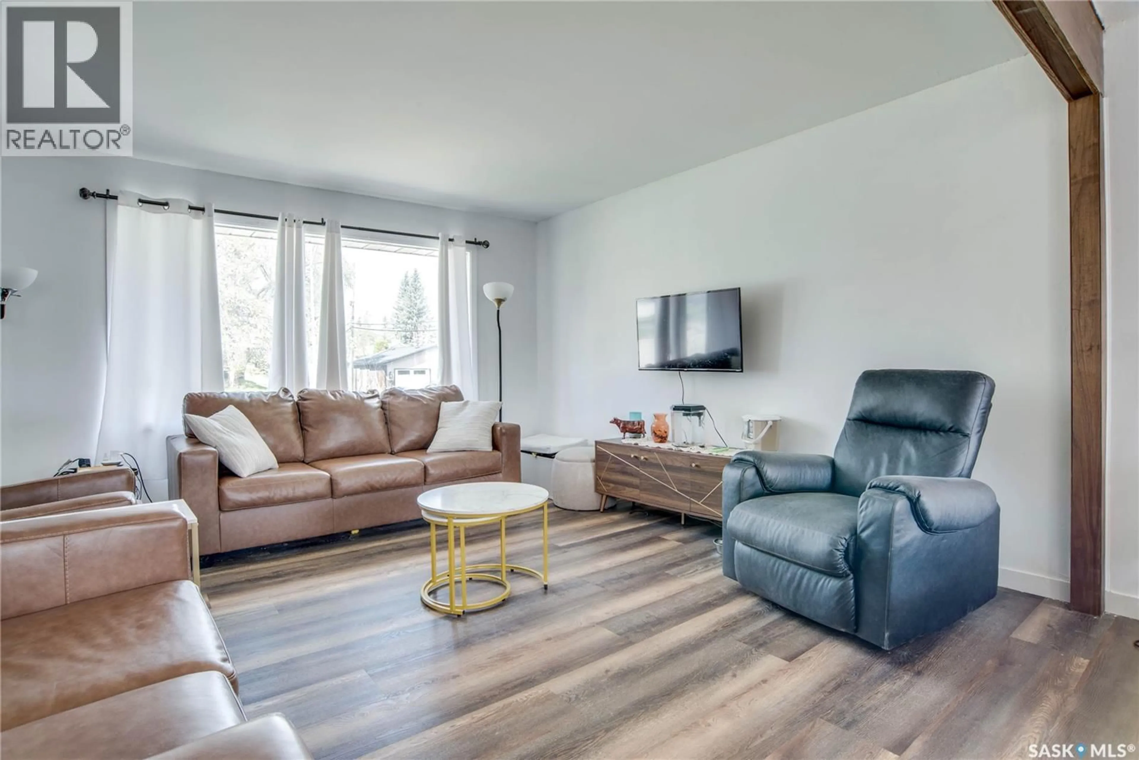 Living room with furniture, wood/laminate floor for 1301 33RD STREET, Saskatoon Saskatchewan S7L0X1