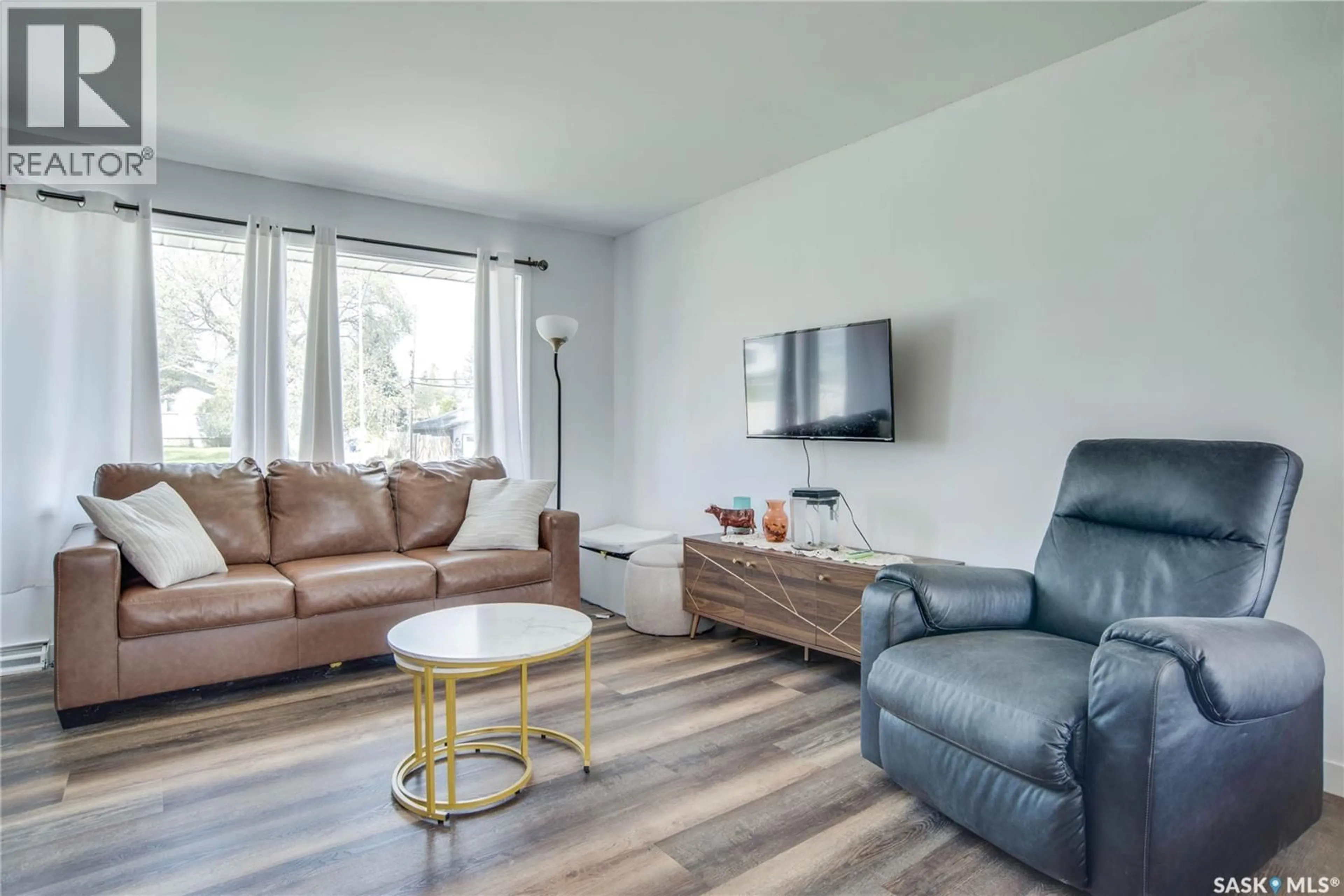 Living room with furniture, wood/laminate floor for 1301 33RD STREET, Saskatoon Saskatchewan S7L0X1