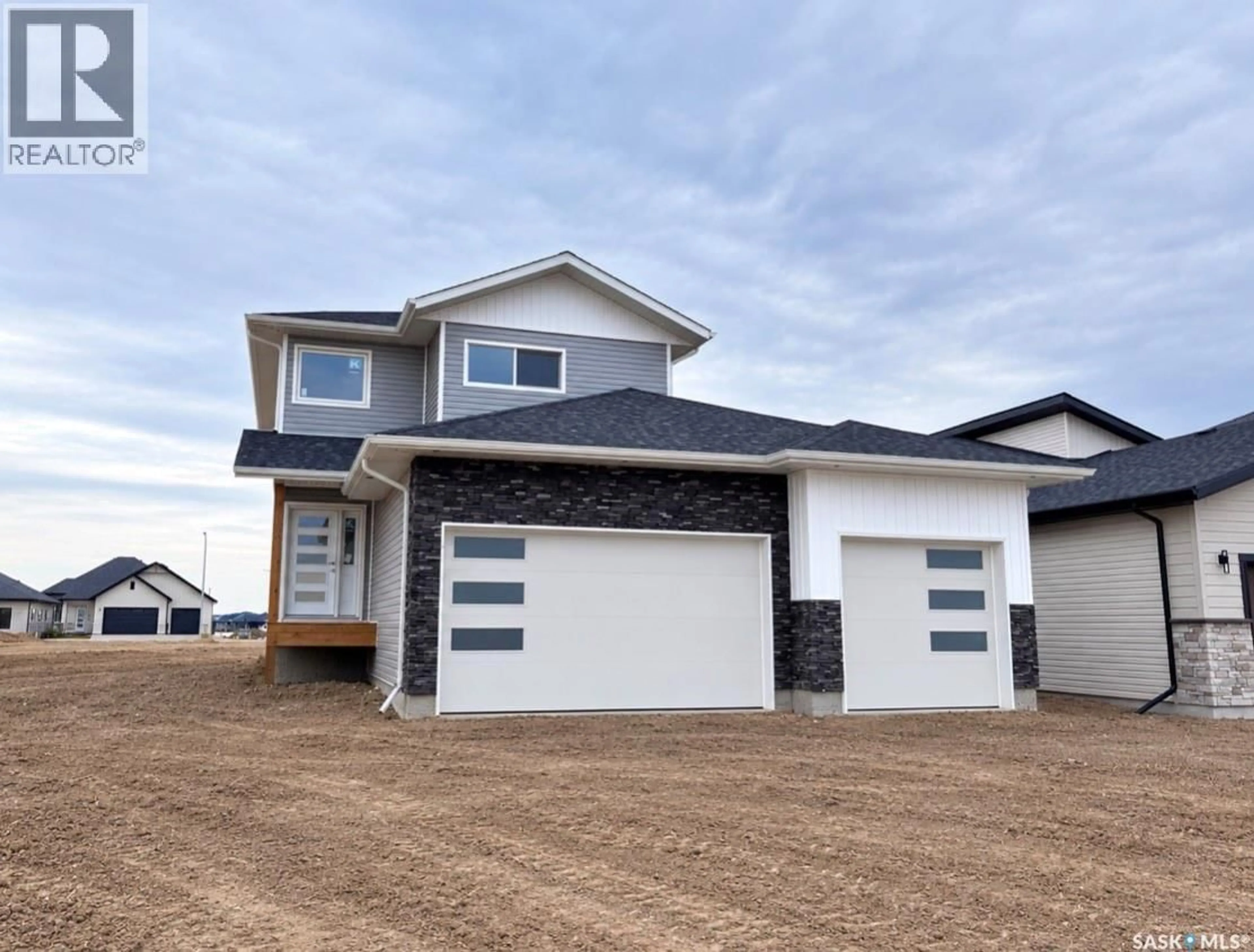 Home with vinyl exterior material, street for 222 VETERANS DRIVE, Warman Saskatchewan S0K4S4