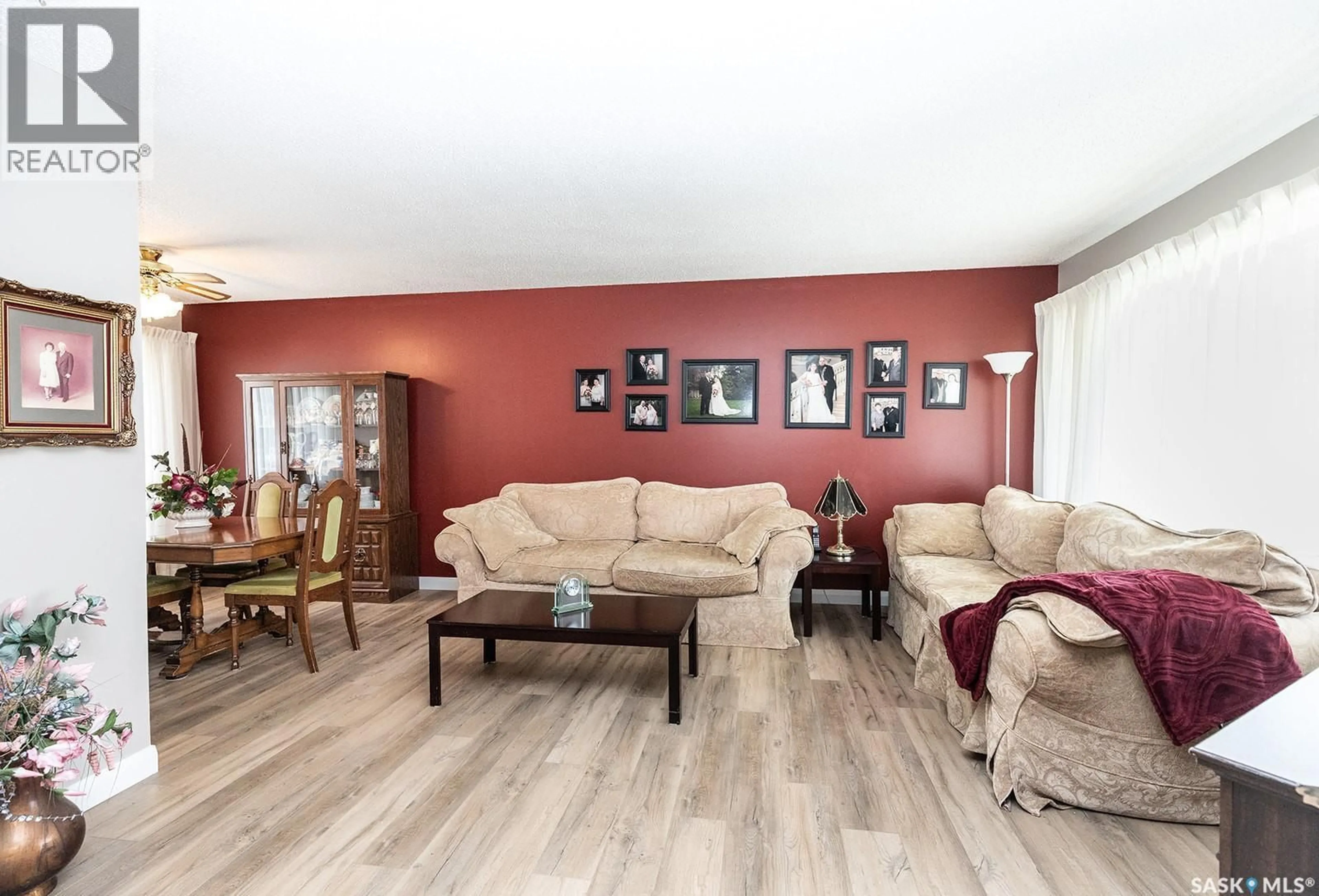 Living room with furniture, wood/laminate floor for 43 LINDSAY DRIVE, Saskatoon Saskatchewan S7H3E2