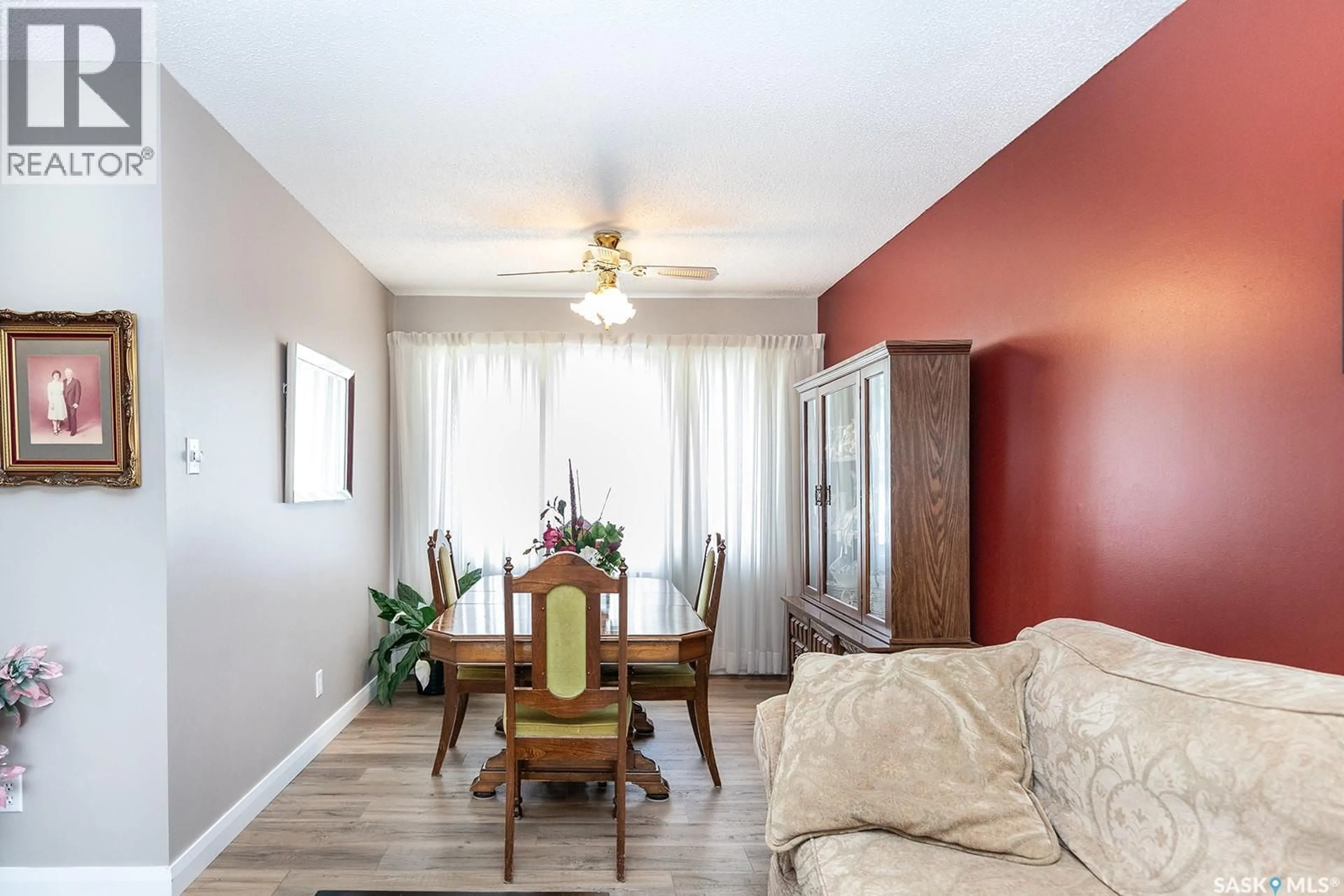 Living room with furniture, wood/laminate floor for 43 LINDSAY DRIVE, Saskatoon Saskatchewan S7H3E2