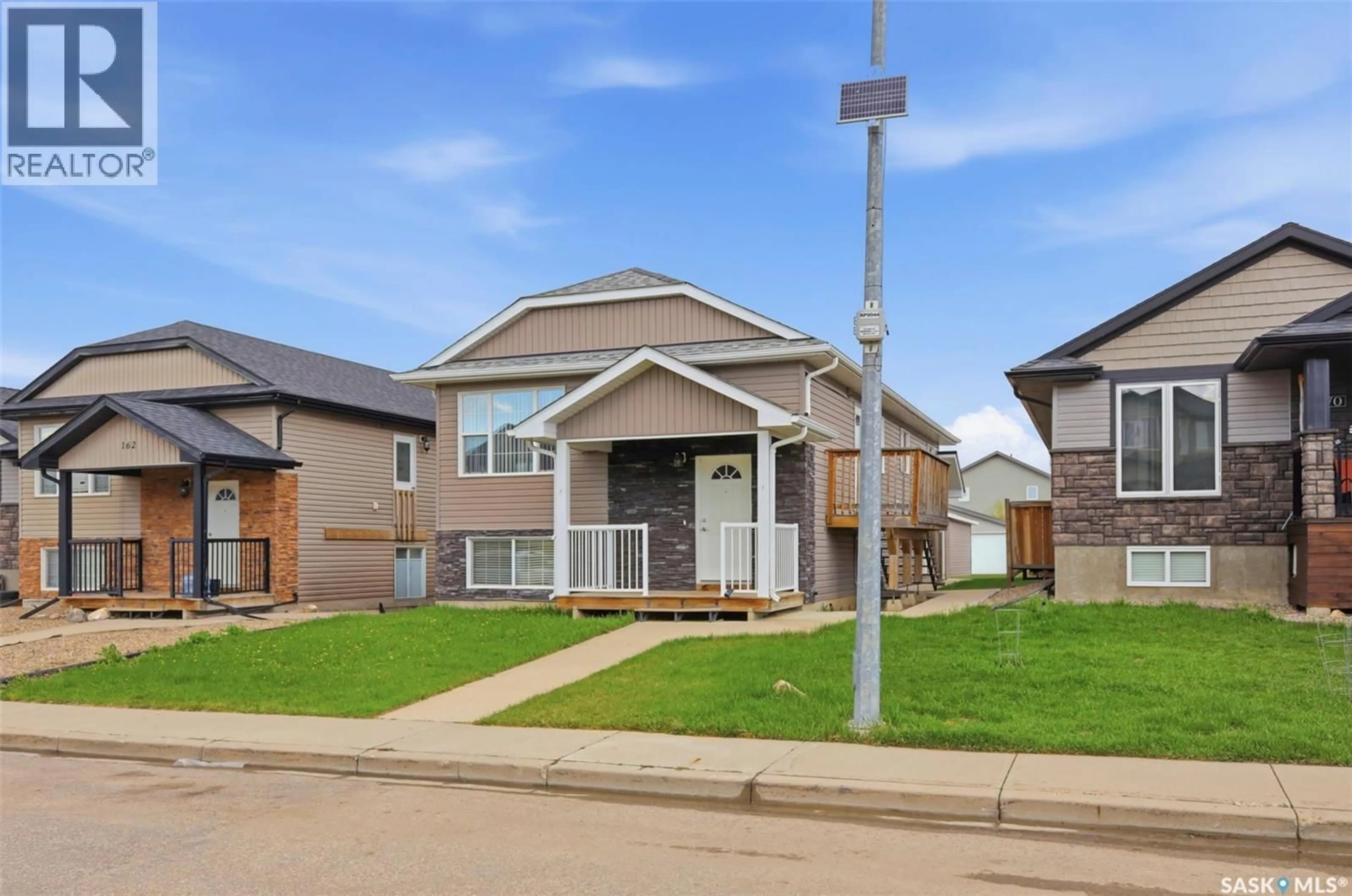 Home with vinyl exterior material, street for 166 RAJPUT WAY, Saskatoon Saskatchewan S7W0L5