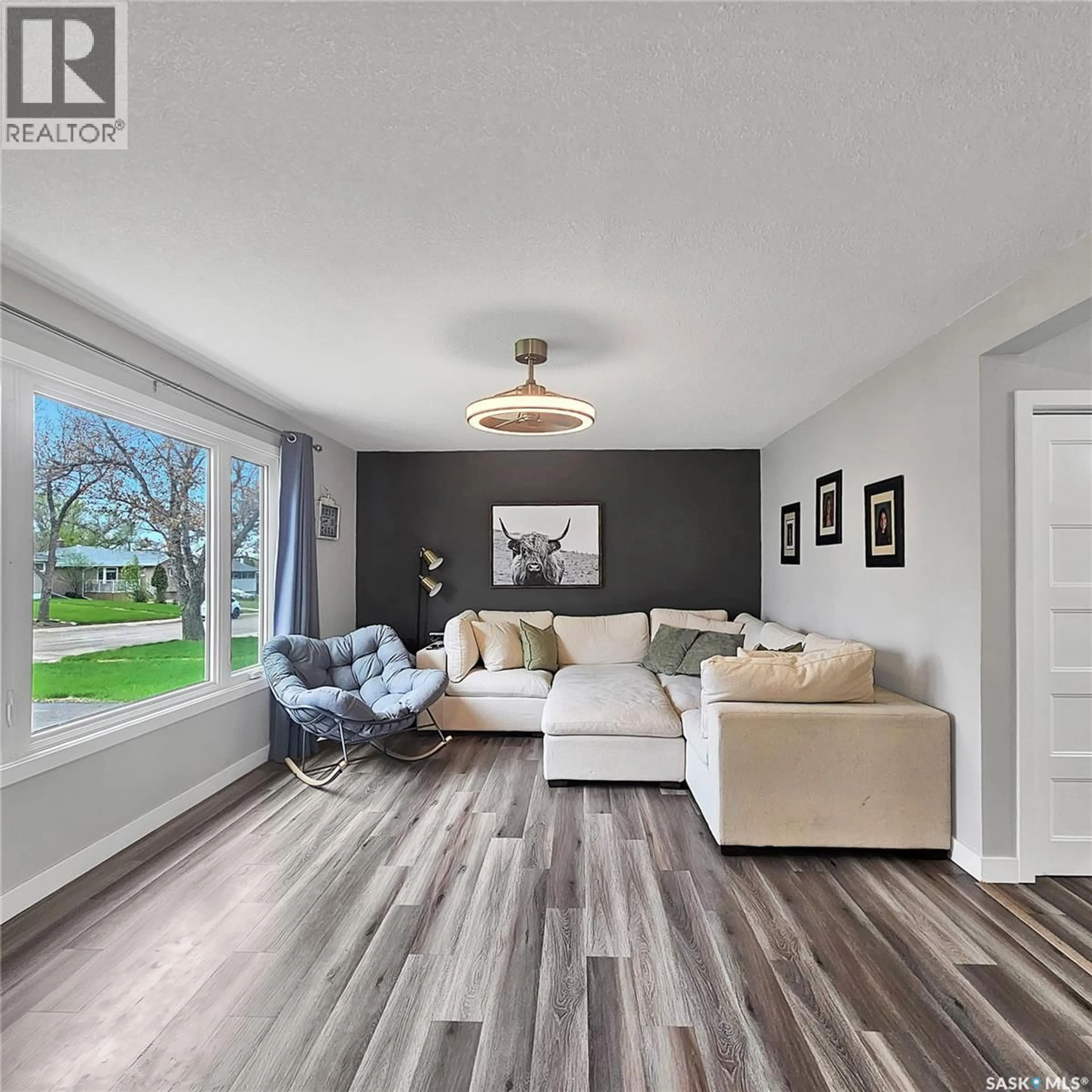 Living room with furniture, wood/laminate floor for 1445 ASHLEY DRIVE, Swift Current Saskatchewan S9H1N6