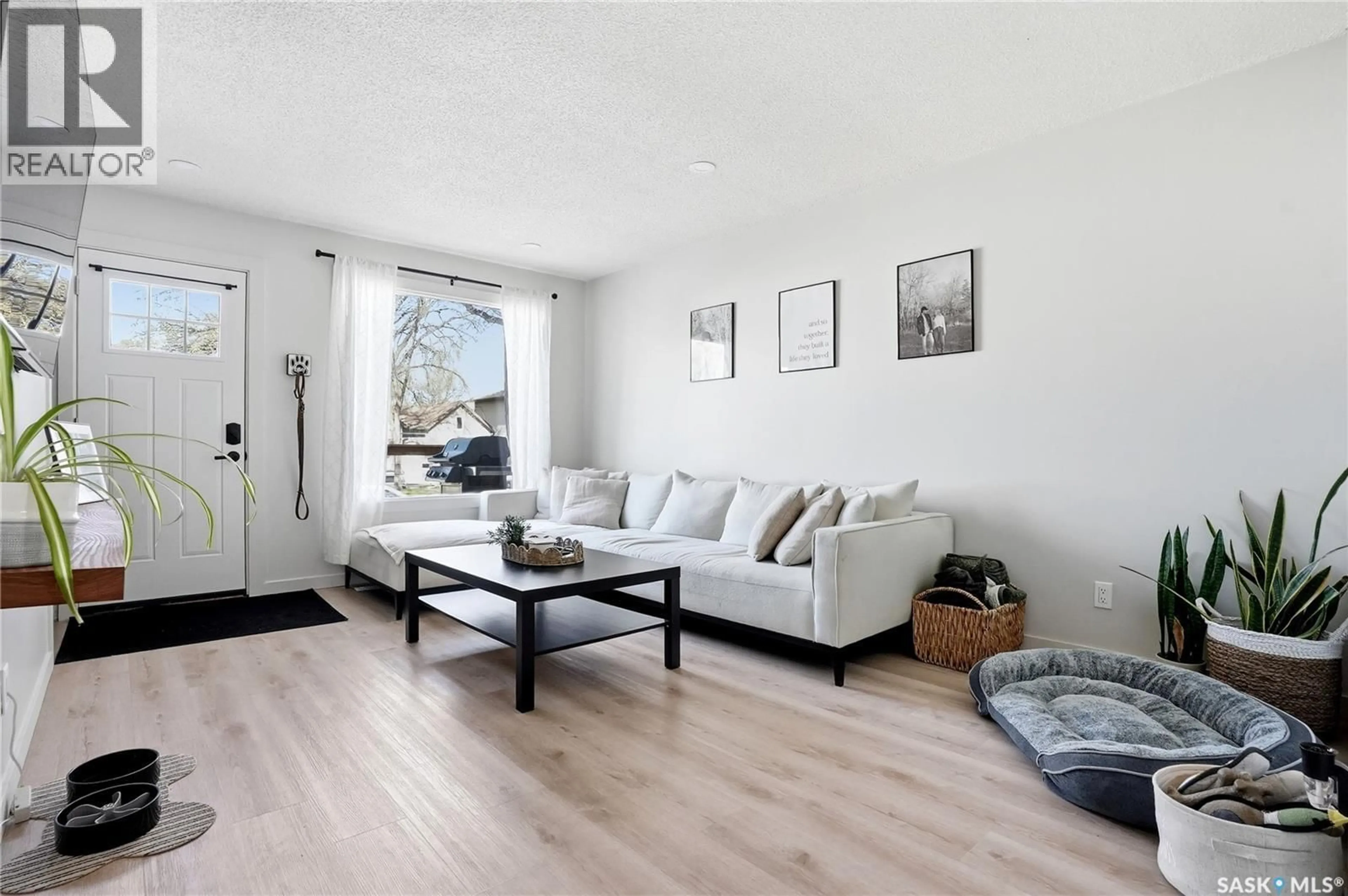Living room with furniture, wood/laminate floor for 1306 6TH AVENUE, Saskatoon Saskatchewan S7K2T8