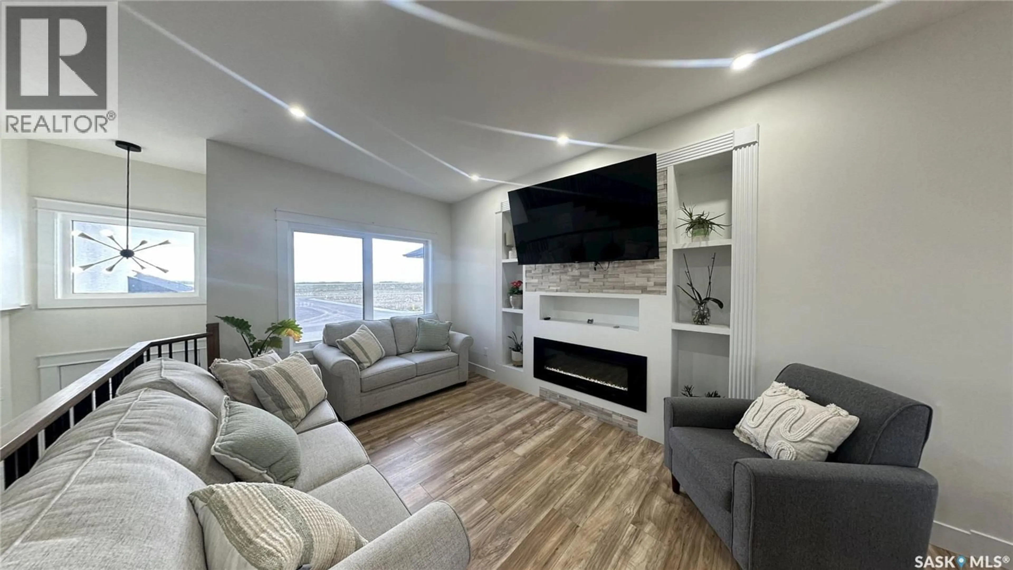 Living room with furniture, wood/laminate floor for 2535 ROSEWOOD DRIVE, Saskatoon Saskatchewan S7V0L8