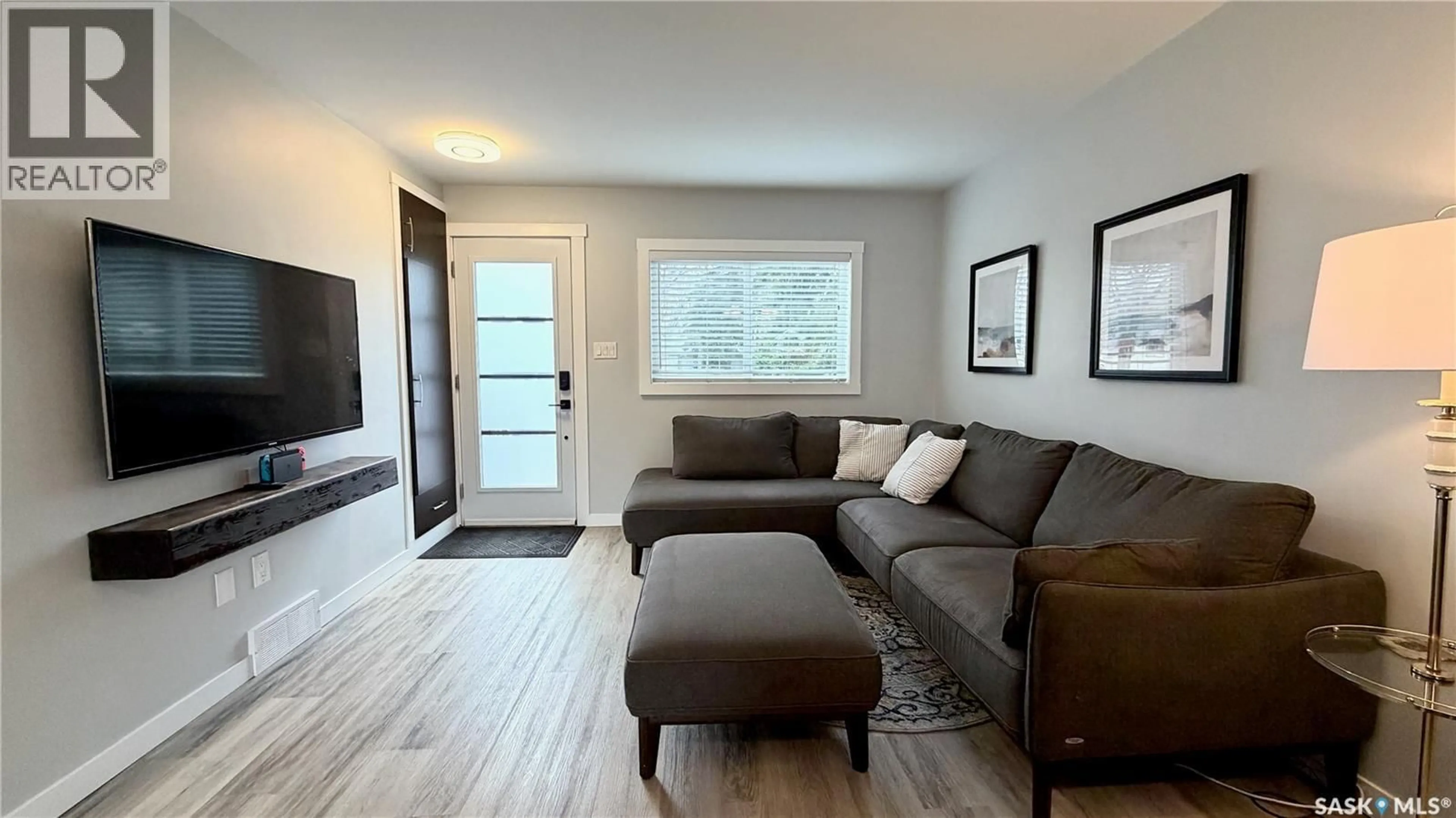 Living room with furniture, wood/laminate floor for 2414 MELROSE AVENUE, Saskatoon Saskatchewan S7J0V5
