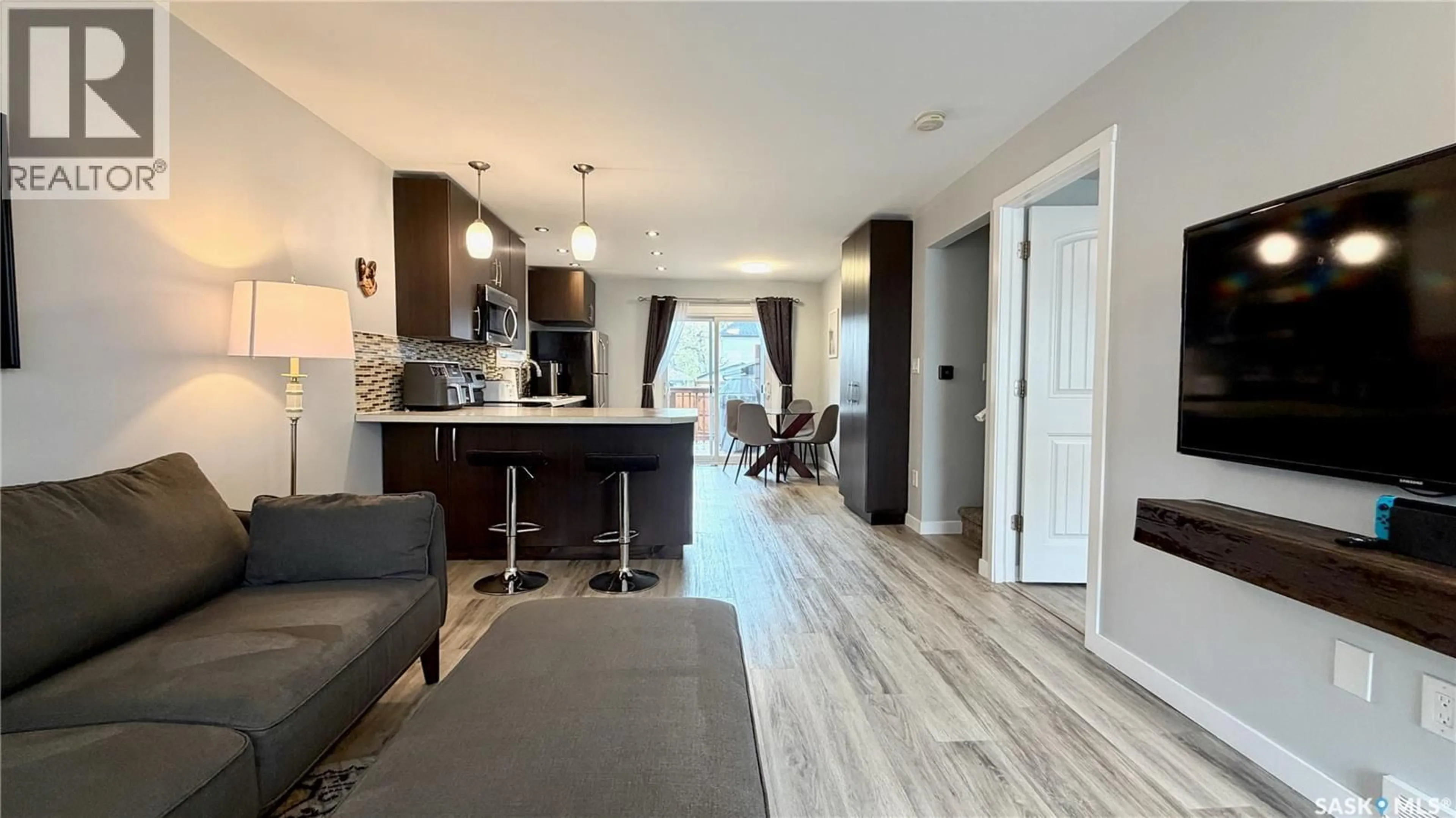 Open concept kitchen, wood/laminate floor for 2414 MELROSE AVENUE, Saskatoon Saskatchewan S7J0V5