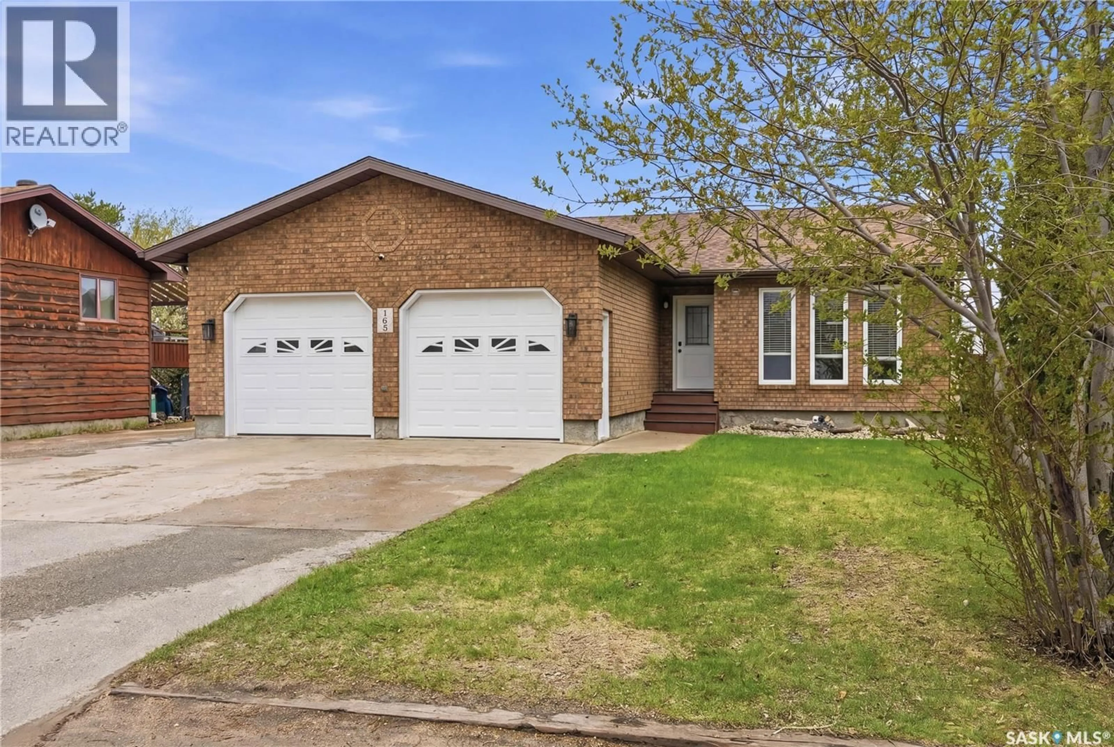 Home with brick exterior material, street for 165 3RD STREET, Pilot Butte Saskatchewan S0G3Z0