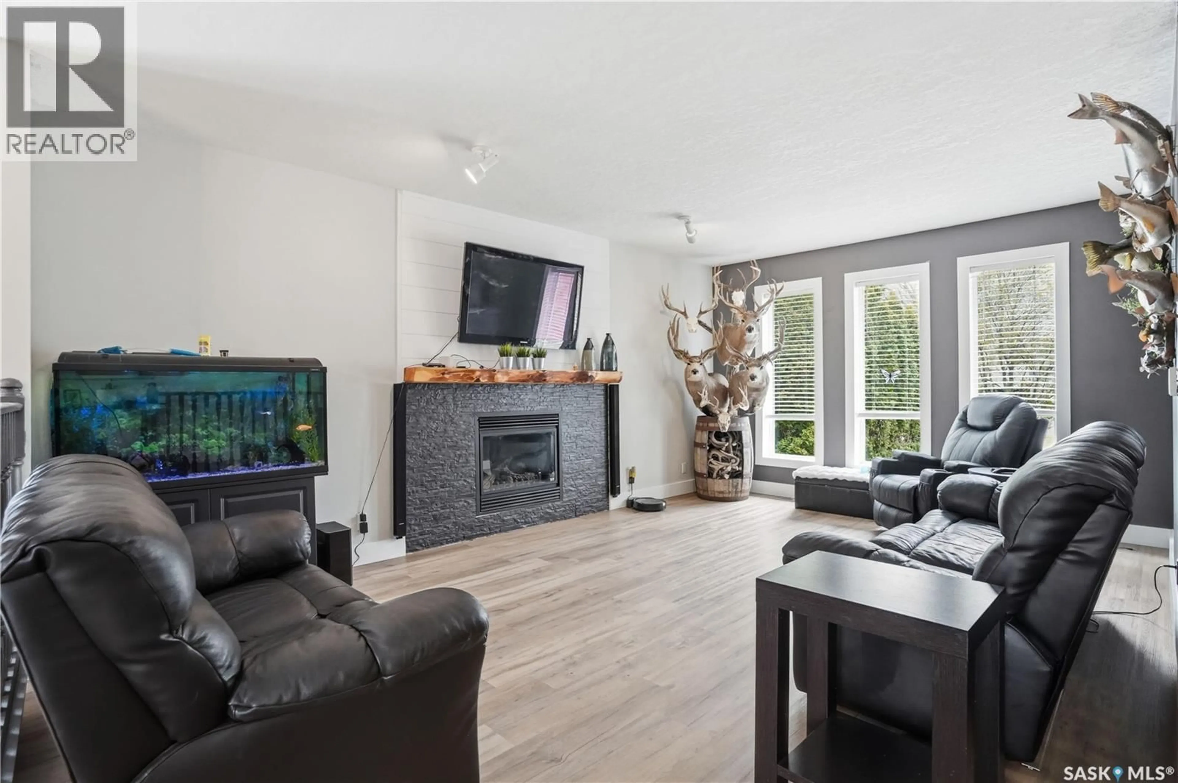 Living room with furniture, wood/laminate floor for 165 3RD STREET, Pilot Butte Saskatchewan S0G3Z0