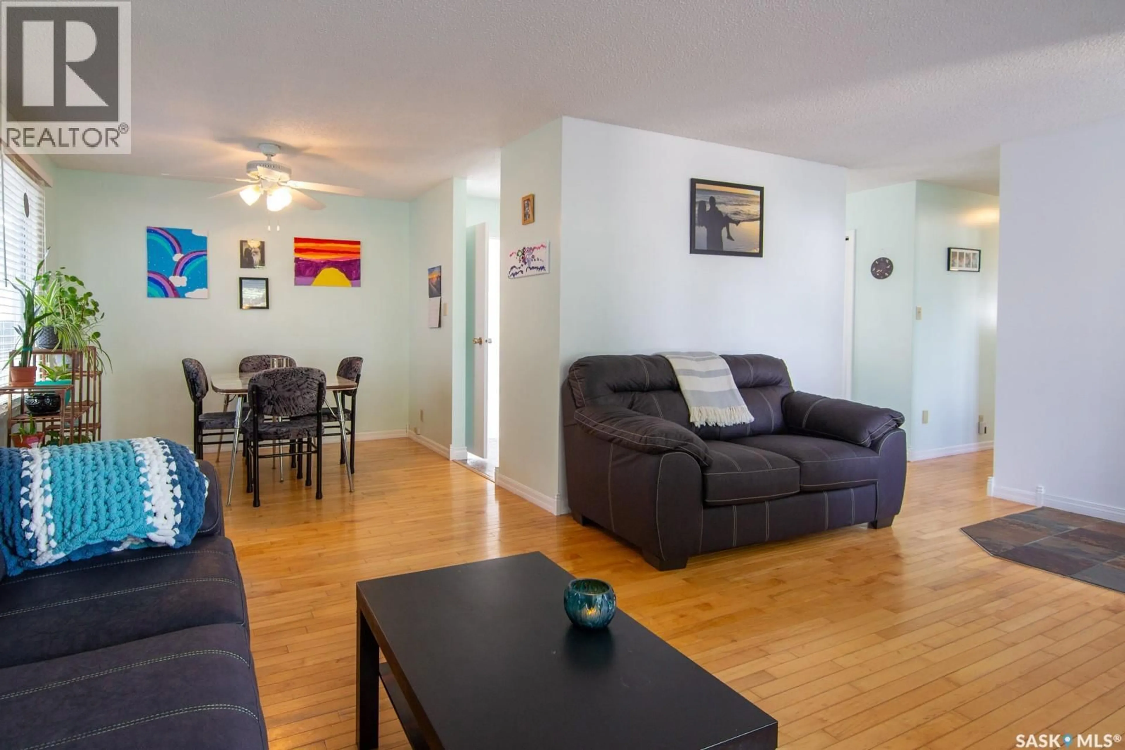 Living room with furniture, wood/laminate floor for 127 DEVONSHIRE CRESCENT, Saskatoon Saskatchewan S7L5V6