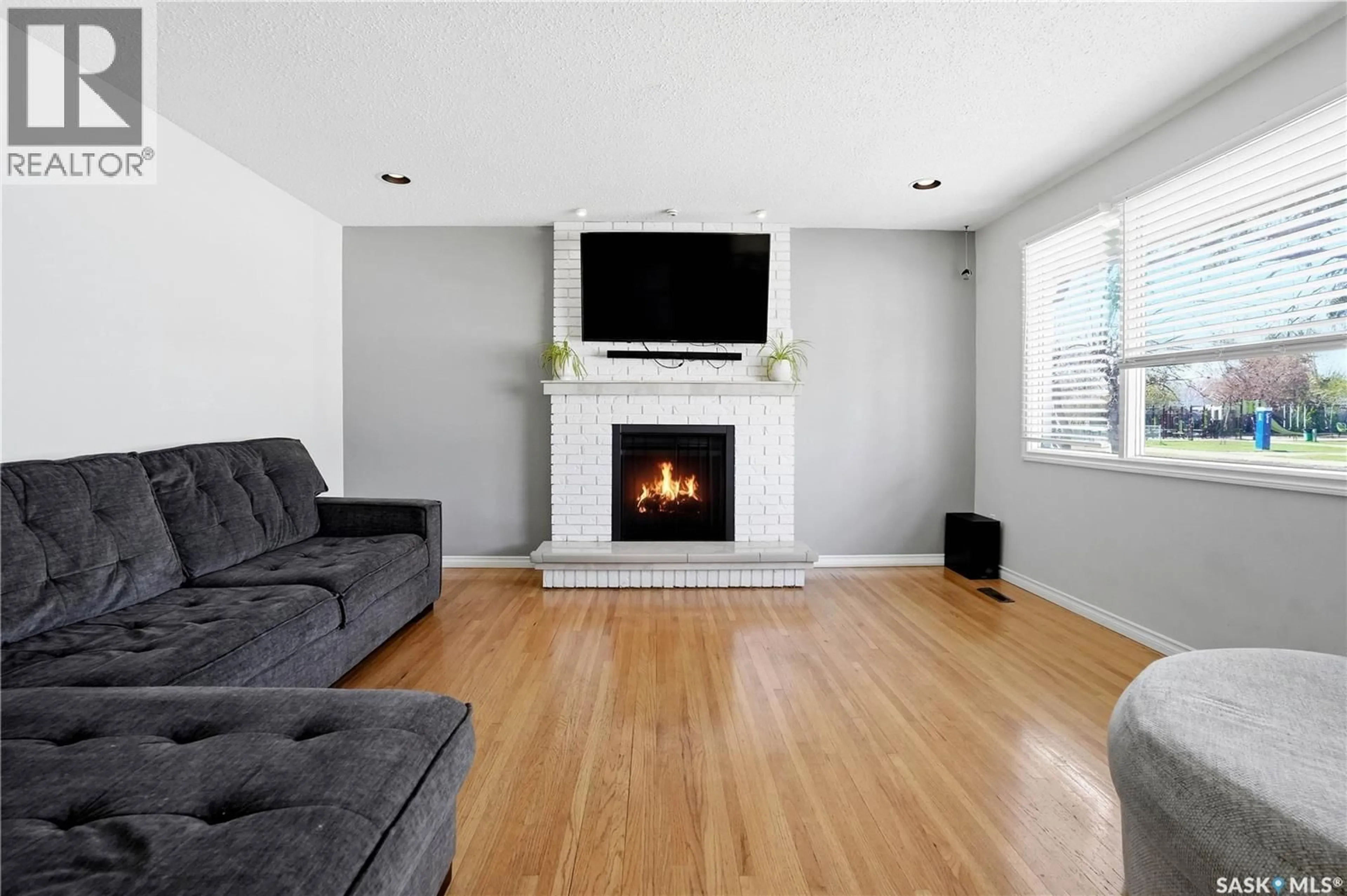 Living room with furniture, wood/laminate floor for 55 DONAHUE AVENUE, Regina Saskatchewan S4R3Y7