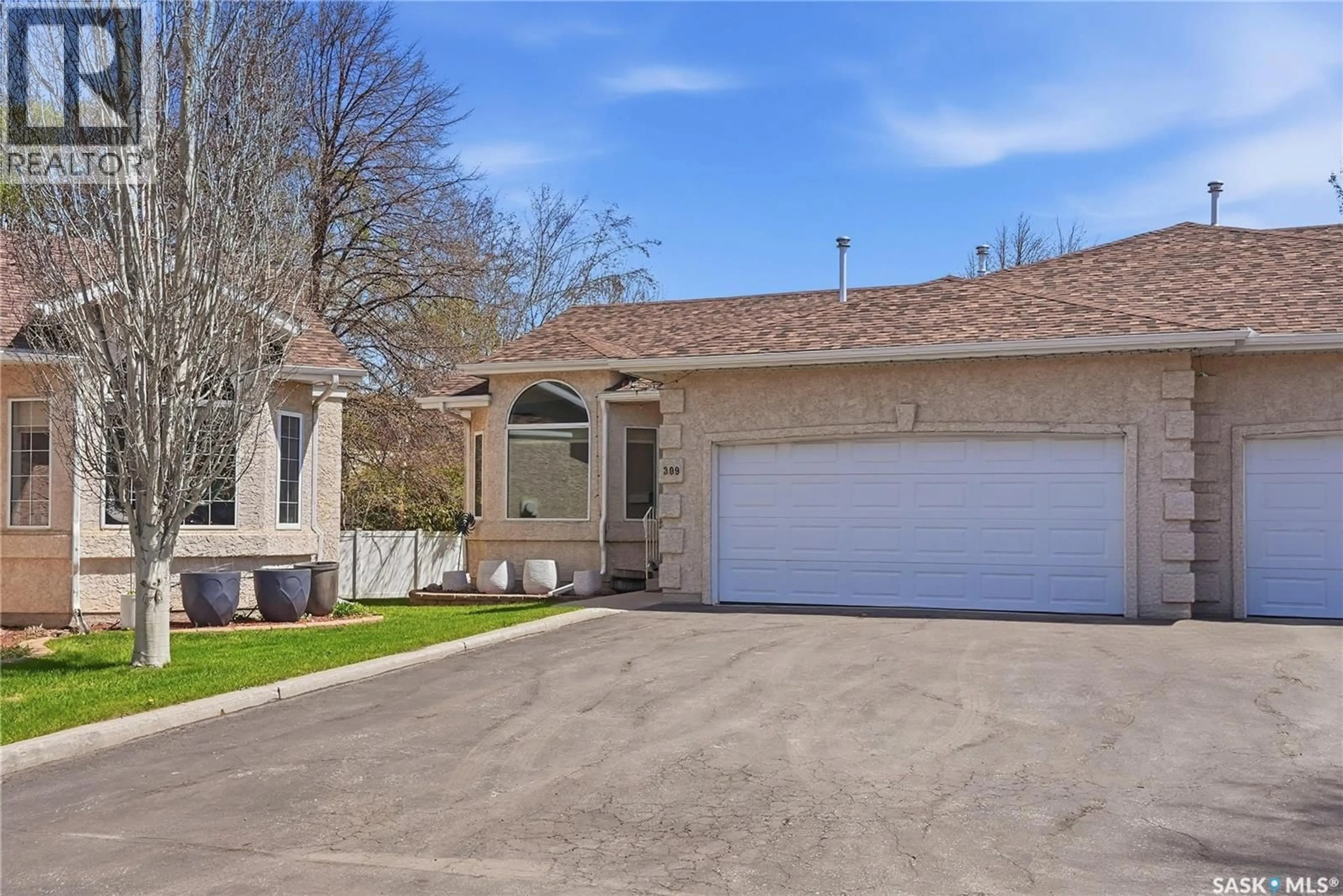 Home with vinyl exterior material, street for 309 315 BERINI DRIVE, Saskatoon Saskatchewan S7N4M1