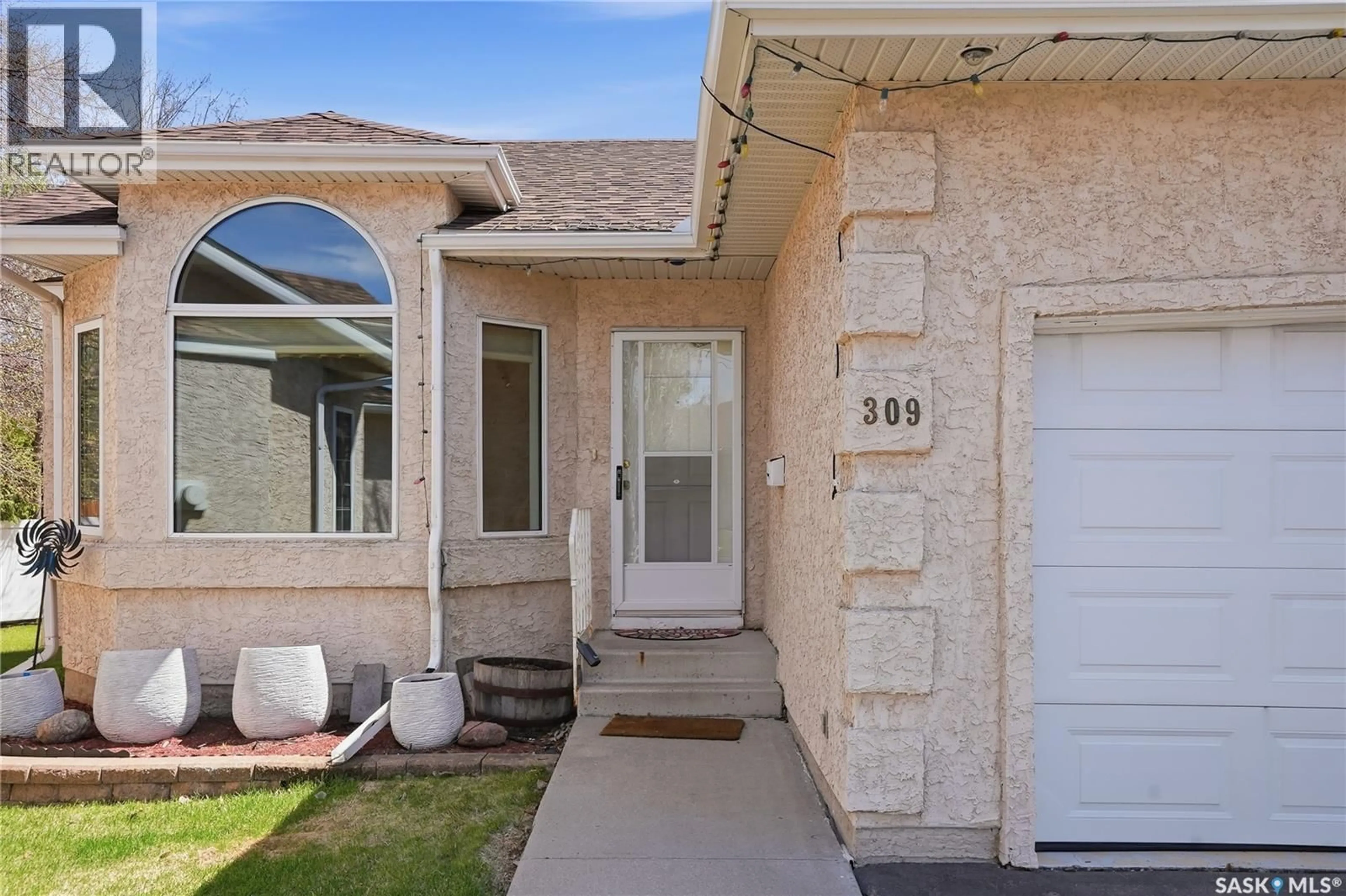 Home with vinyl exterior material, street for 309 315 BERINI DRIVE, Saskatoon Saskatchewan S7N4M1