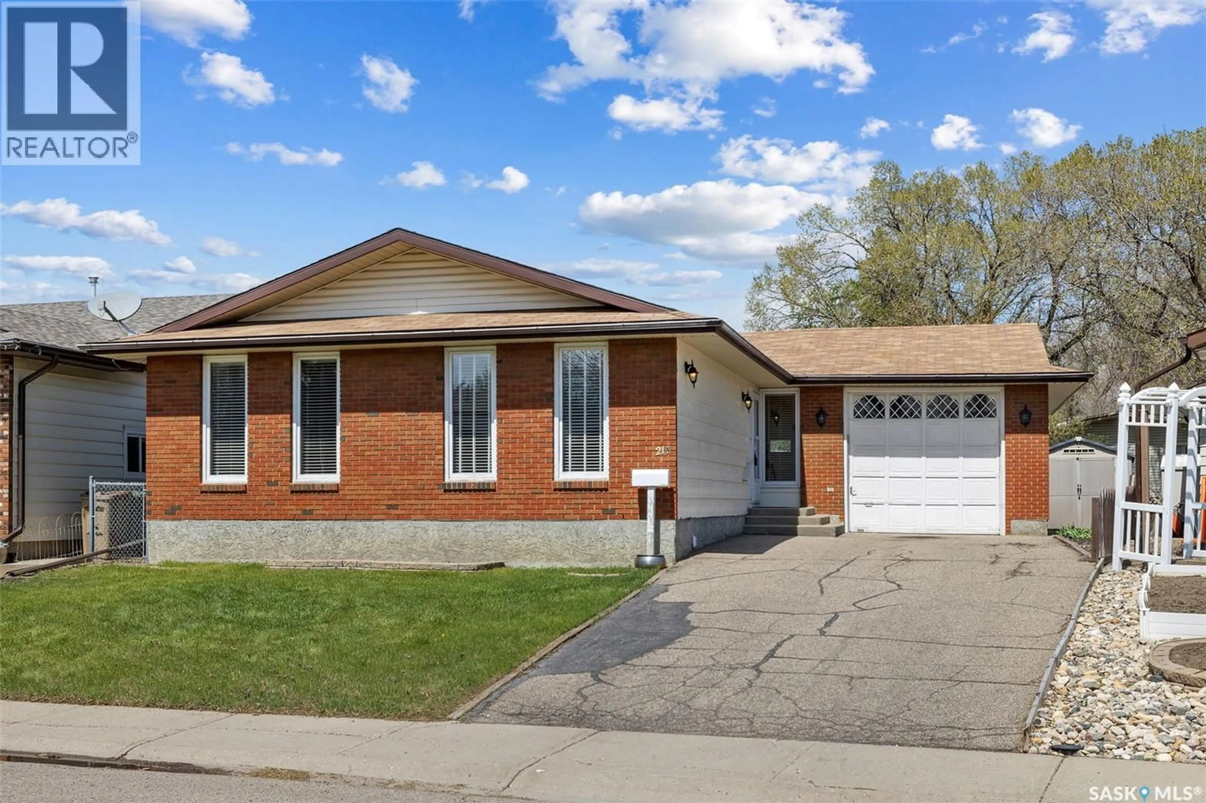Home with brick exterior material, street for 21 MERLIN CRESCENT, Regina Saskatchewan S4R3E2