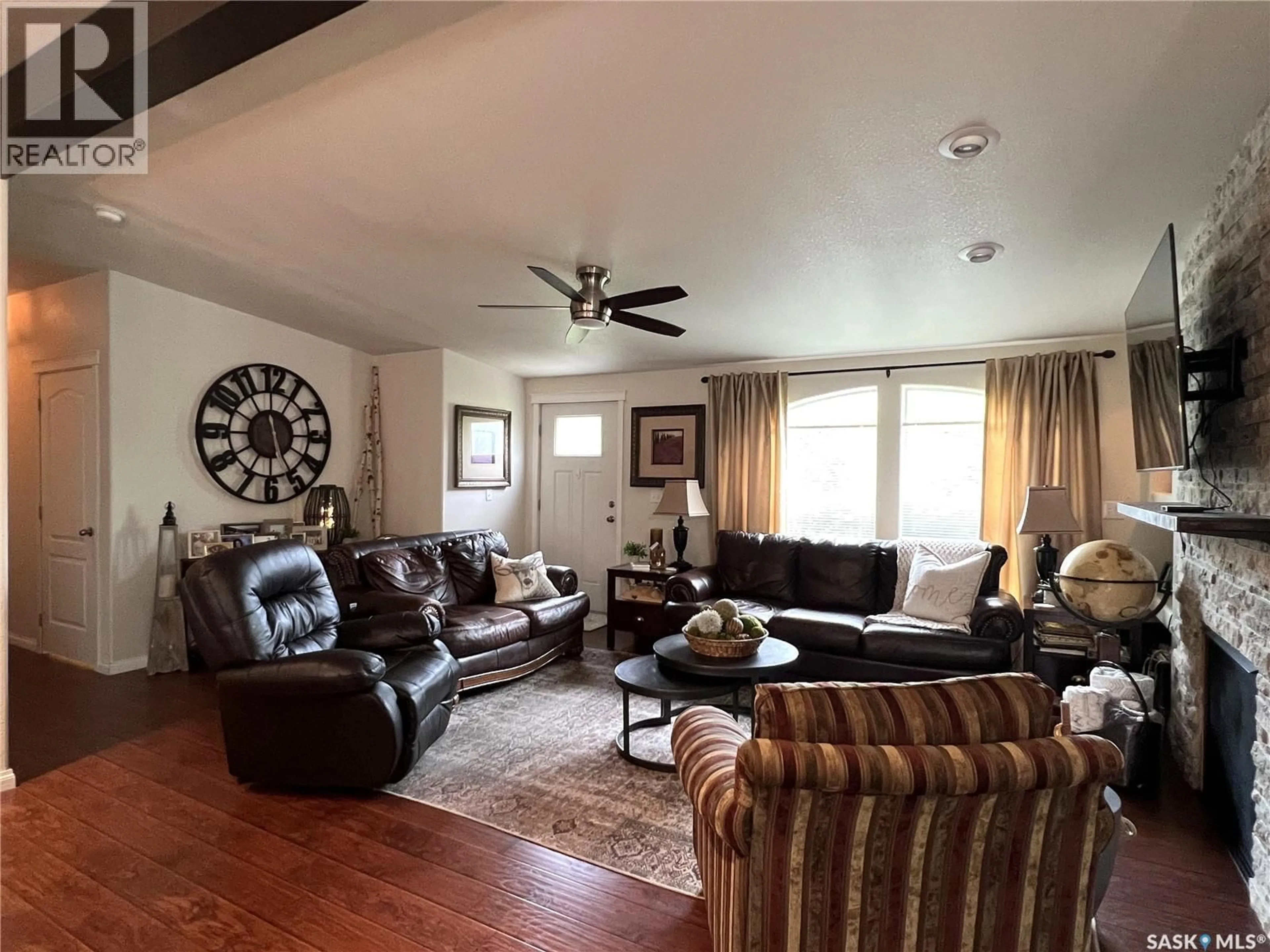 Living room with furniture, wood/laminate floor for 208 2ND AVENUE, Dorintosh Saskatchewan S0M0T0