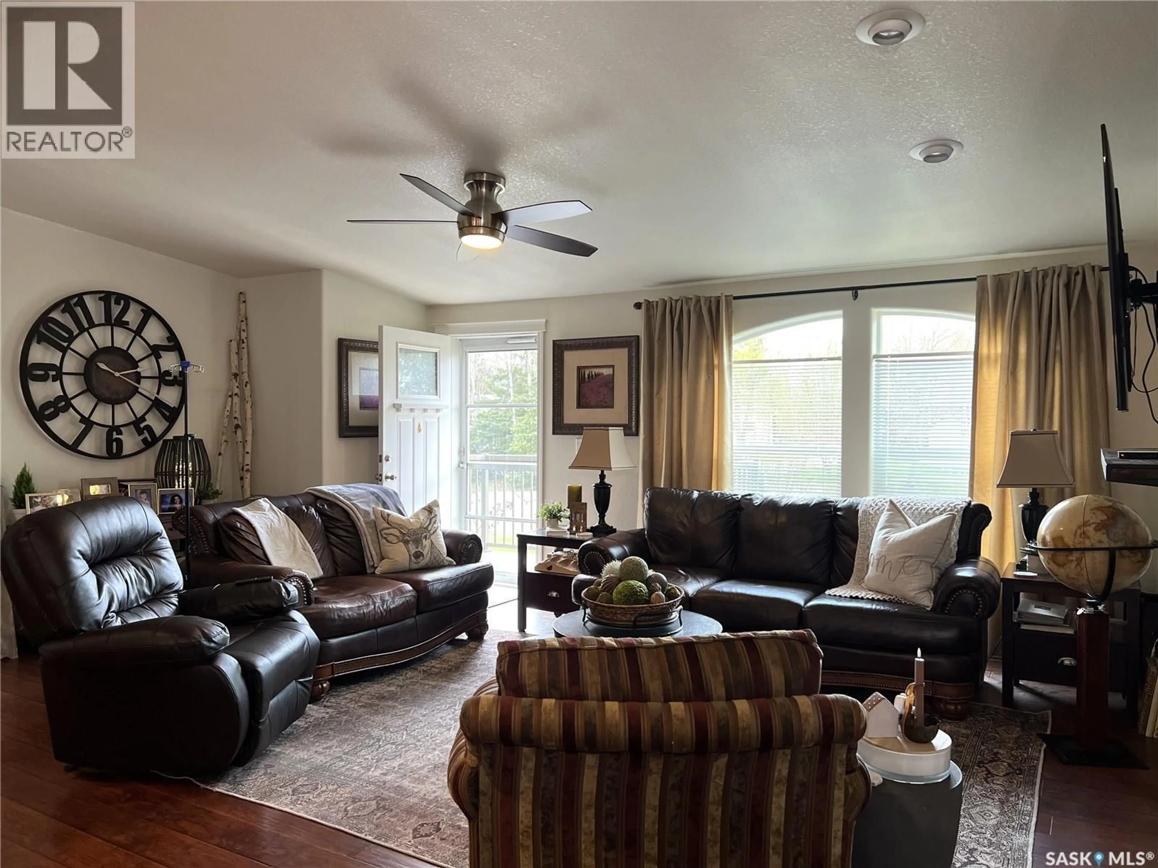 Living room with furniture, wood/laminate floor for 208 2ND AVENUE, Dorintosh Saskatchewan S0M0T0
