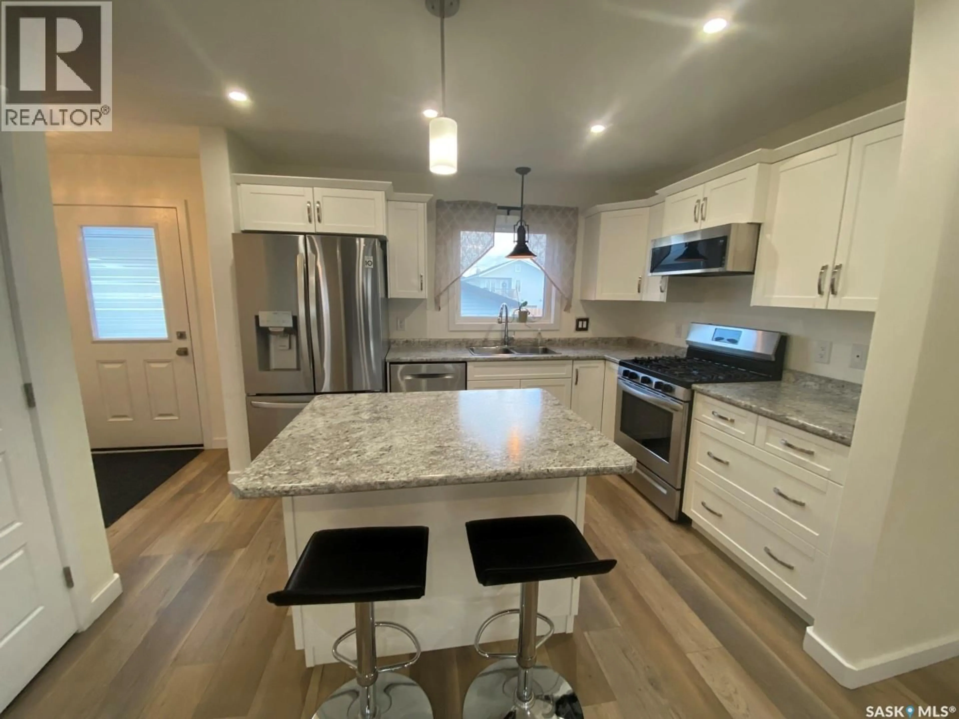 Open concept kitchen, wood/laminate floor for 119 REDDEKOPP CRESCENT, Warman Saskatchewan S0K4S3