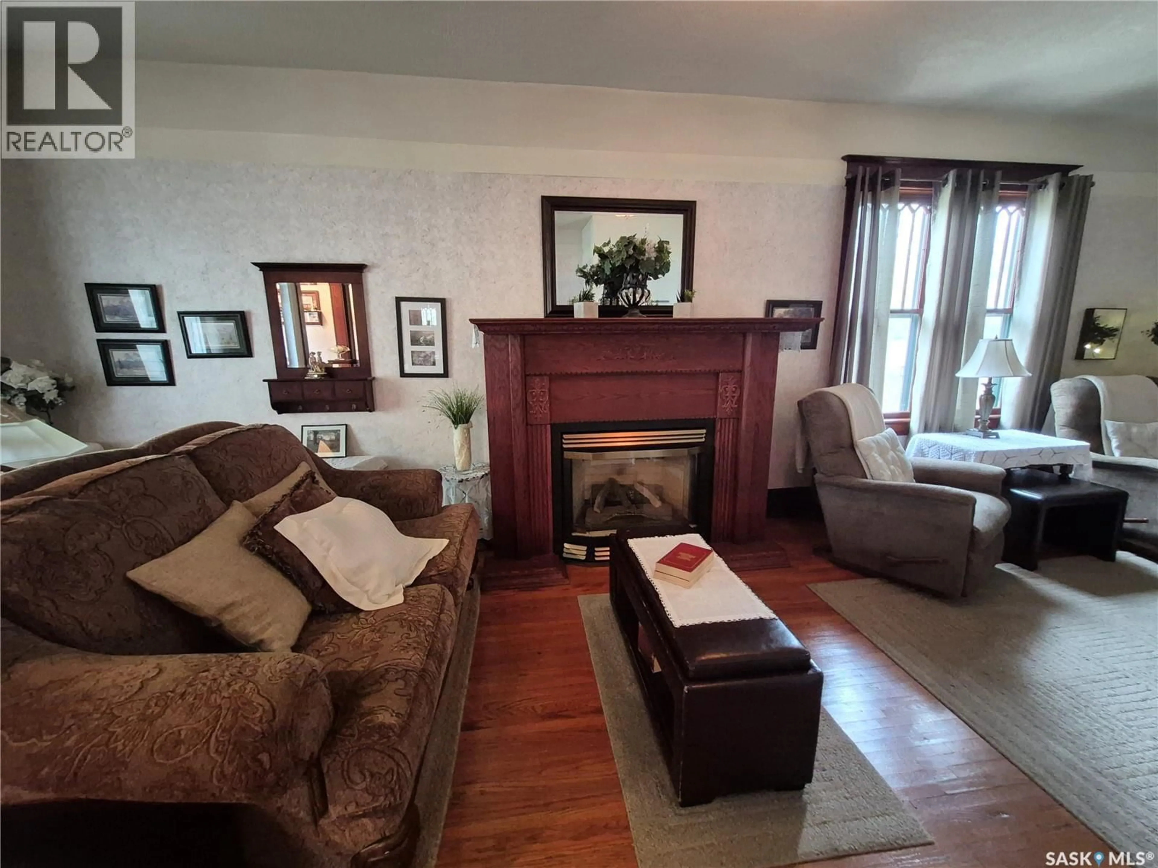 Living room with furniture, wood/laminate floor for 244 3RD AVENUE, Swift Current Saskatchewan S9H0S1