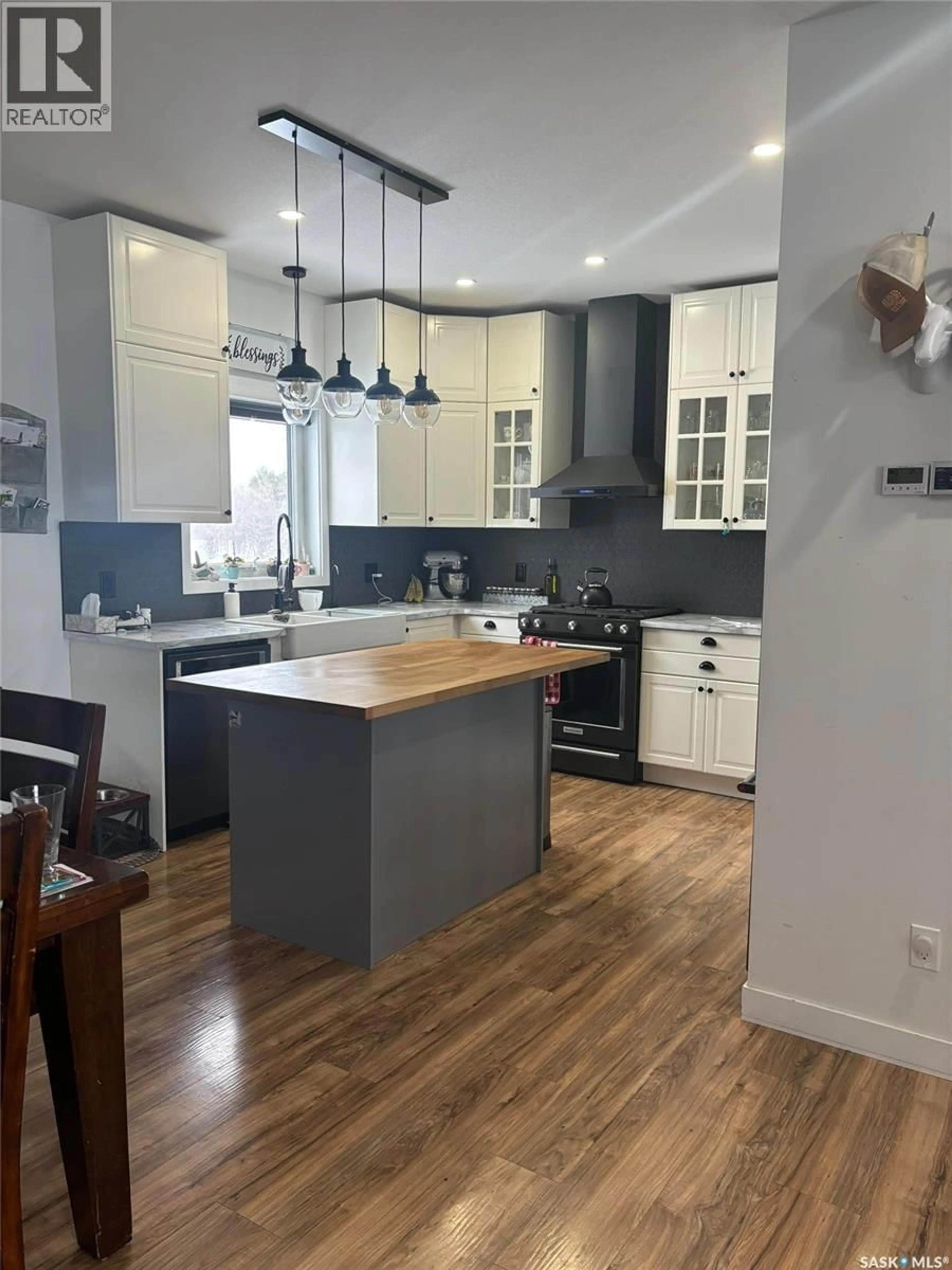 Open concept kitchen, wood/laminate floor for WIWCHAR ACREAGE, Vanscoy Rm No. 345 Saskatchewan S0L2L0