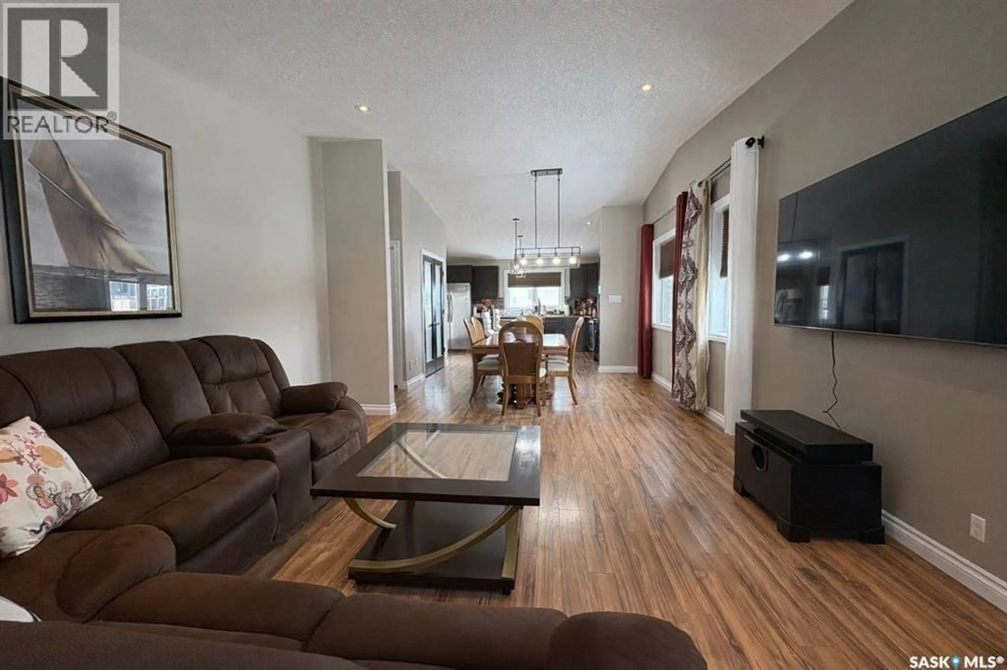 Living room with furniture, wood/laminate floor for 4301 GREEN POPLAR LANE, Regina Saskatchewan S4V1R1