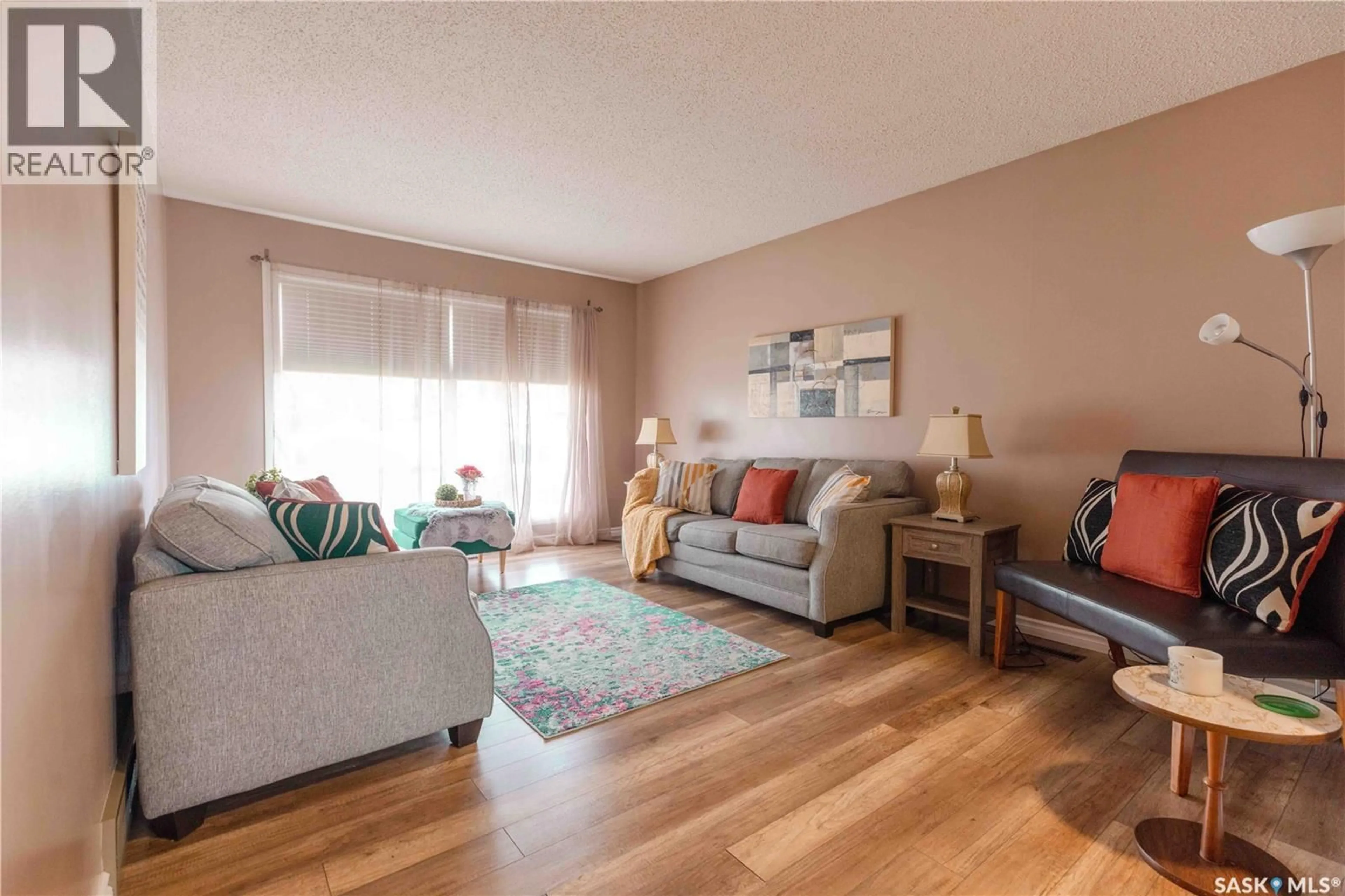 Living room with furniture, wood/laminate floor for 466 SMITH CRESCENT, Saskatoon Saskatchewan S7M5A1