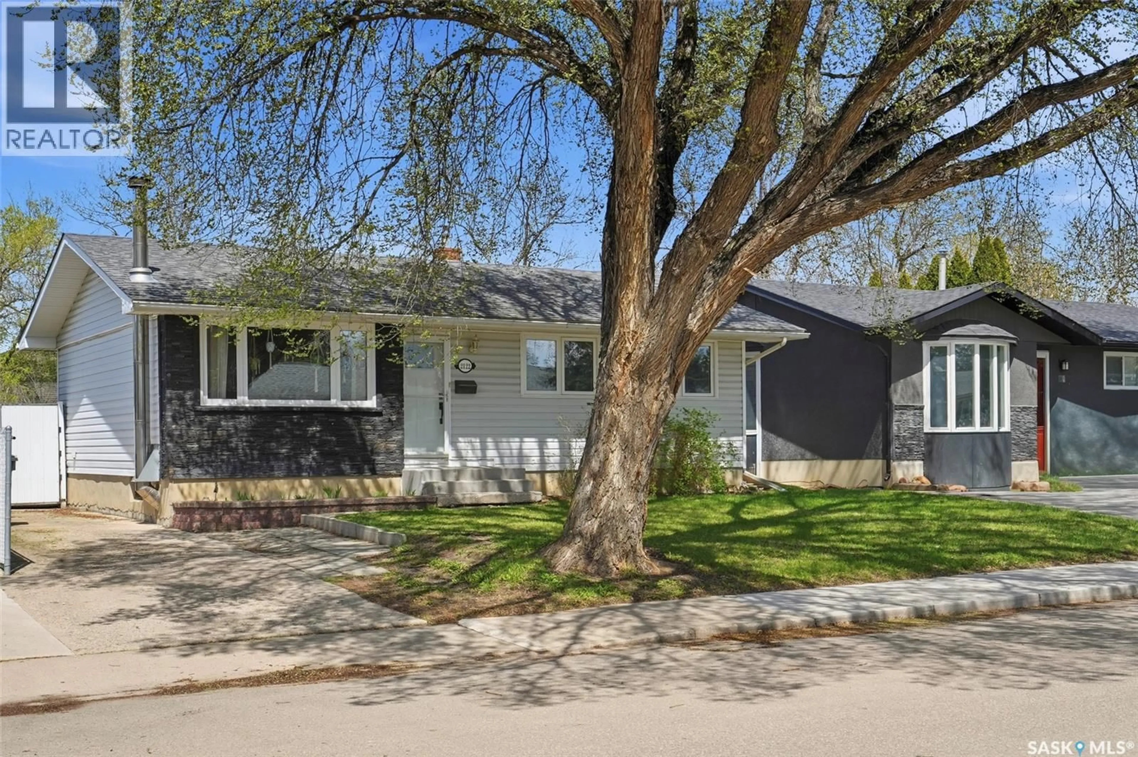 Home with vinyl exterior material, street for 2122 37TH STREET, Saskatoon Saskatchewan S7L4E3