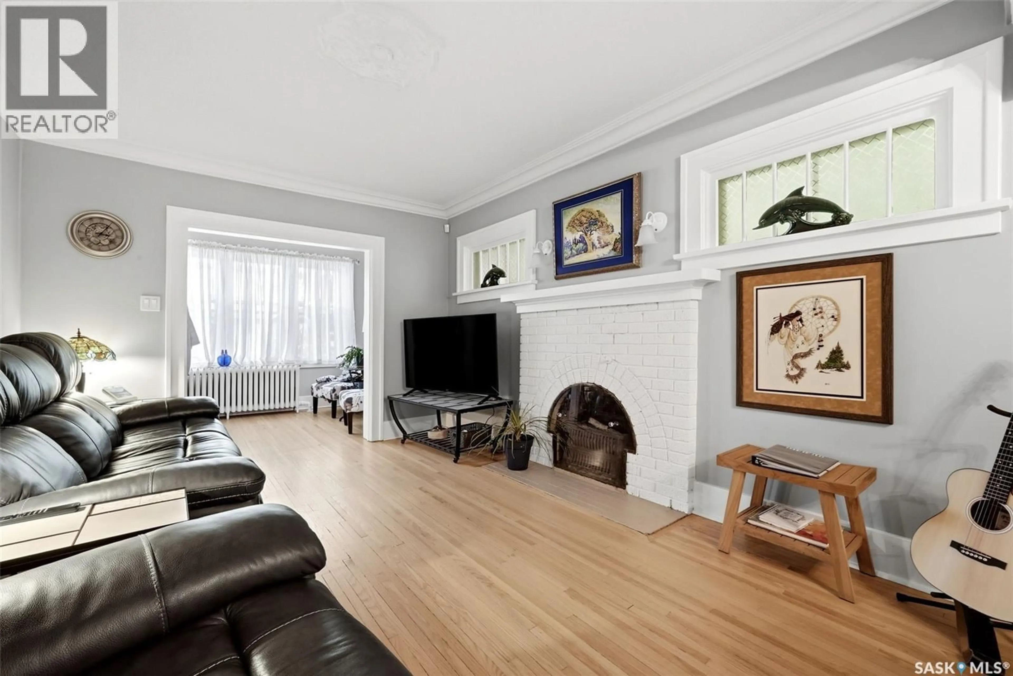 Living room with furniture, wood/laminate floor for 3311 13TH AVENUE, Regina Saskatchewan S4T1P6