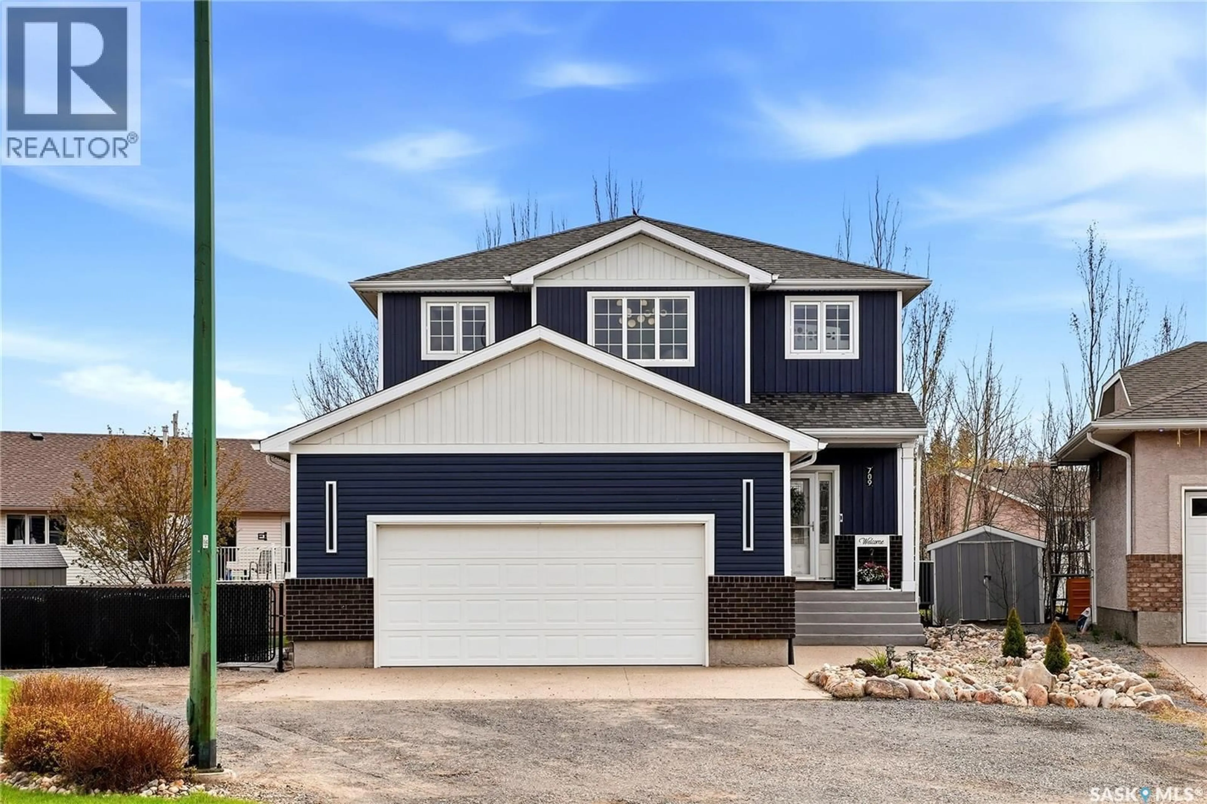 Home with vinyl exterior material, street for 709 ASPEN CRESCENT, Pilot Butte Saskatchewan S0G3Z0
