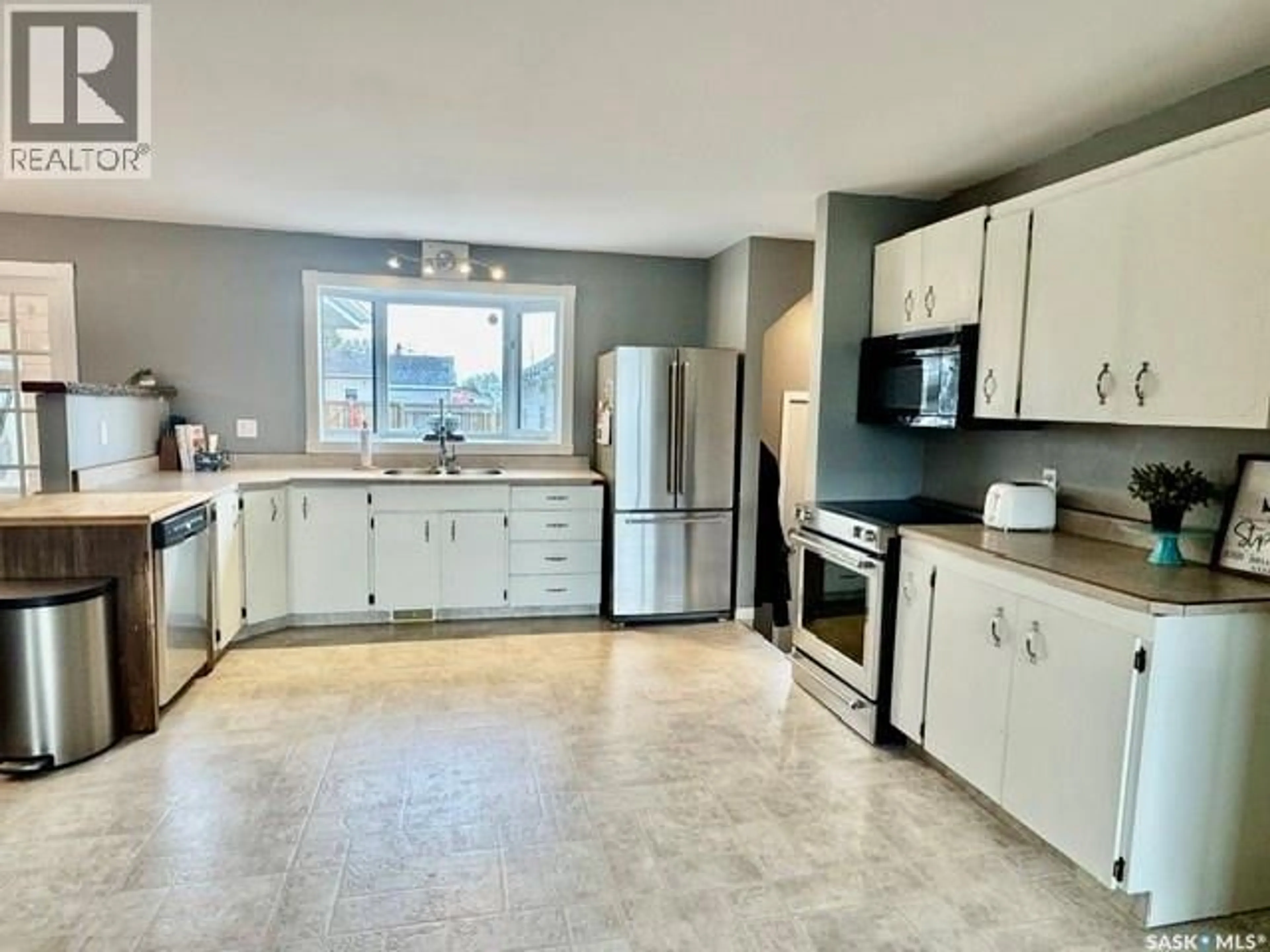 Open concept kitchen, ceramic/tile floor for 55 FOLLEY CRESCENT, Lanigan Saskatchewan S0K2M0