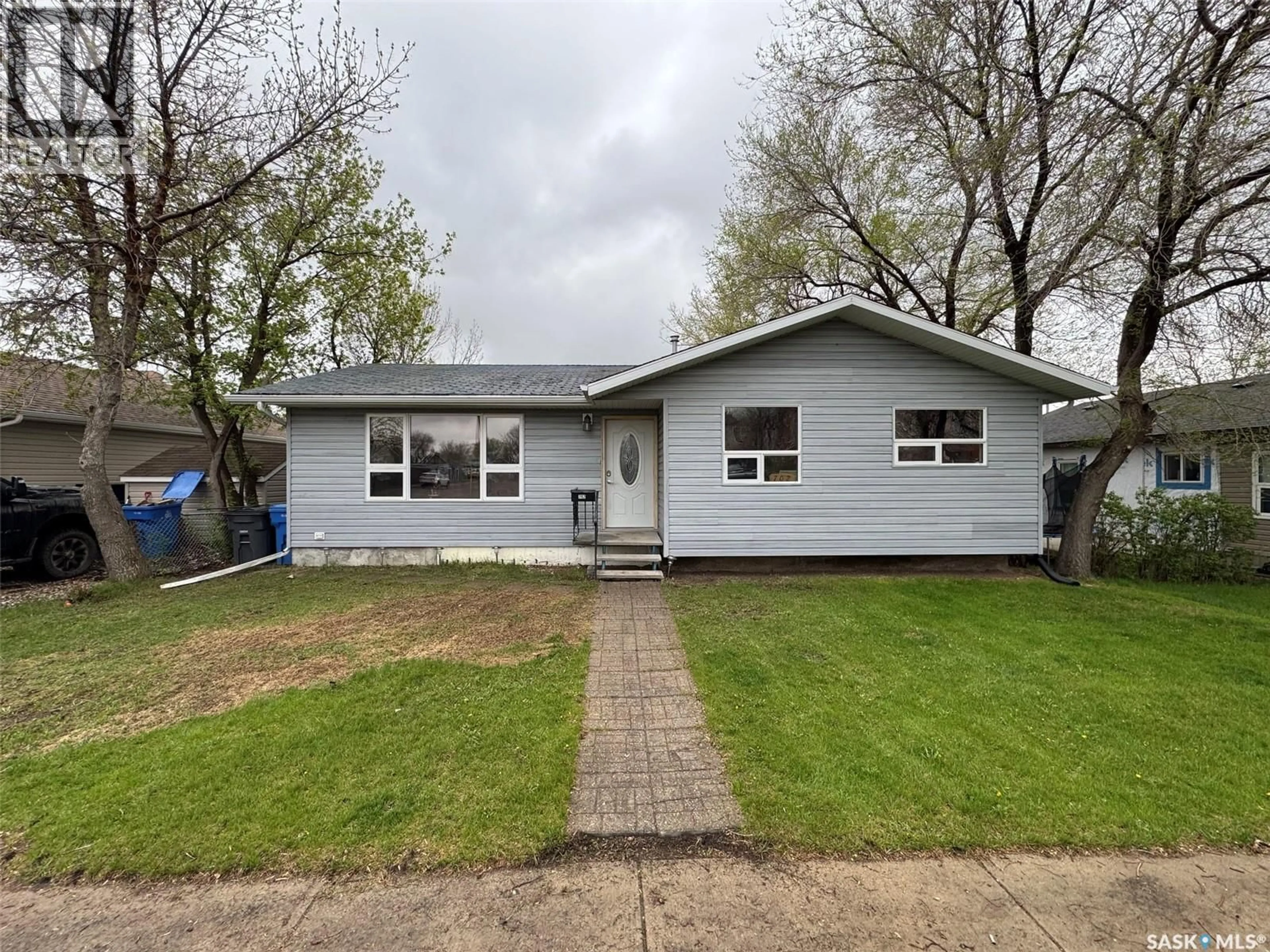 Home with vinyl exterior material, street for 702 SECOND STREET, Estevan Saskatchewan S4A2B3