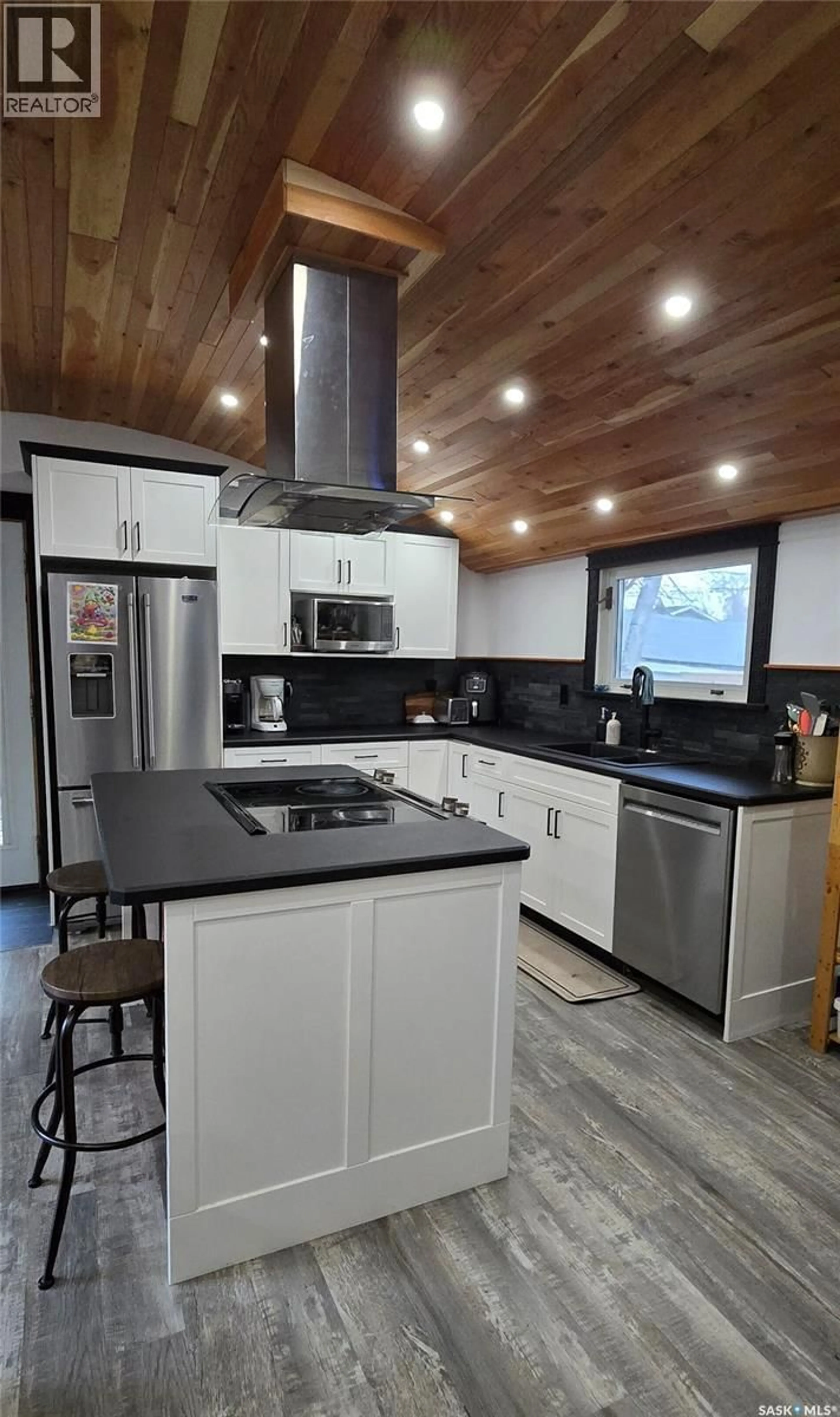 Open concept kitchen, wood/laminate floor for 34 OKADOCA STREET, Kenosee Lake Saskatchewan S0C2S0