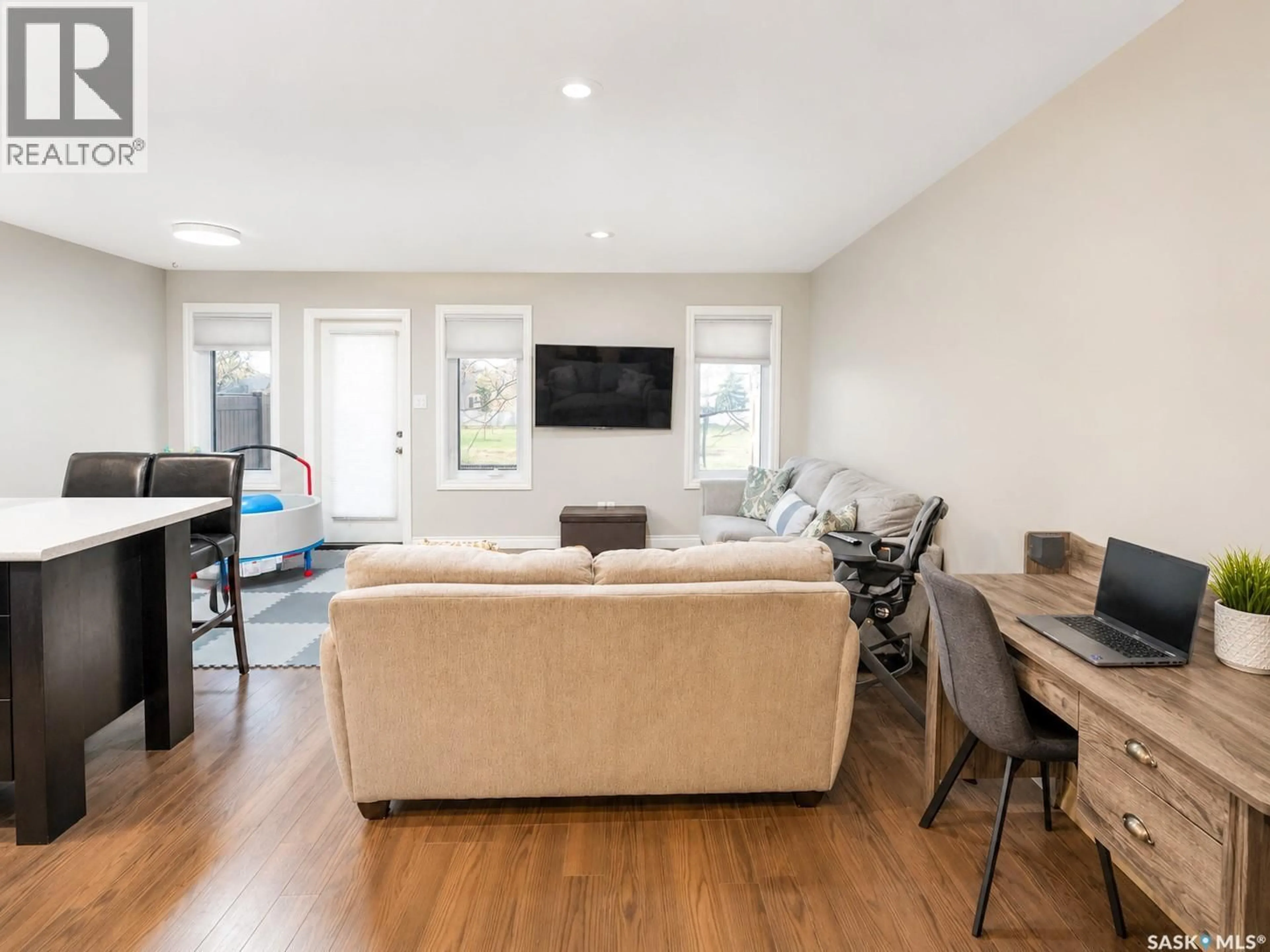 Living room with furniture, wood/laminate floor for 122 DEMARCO POINTE LANE, Regina Saskatchewan S4T1E8