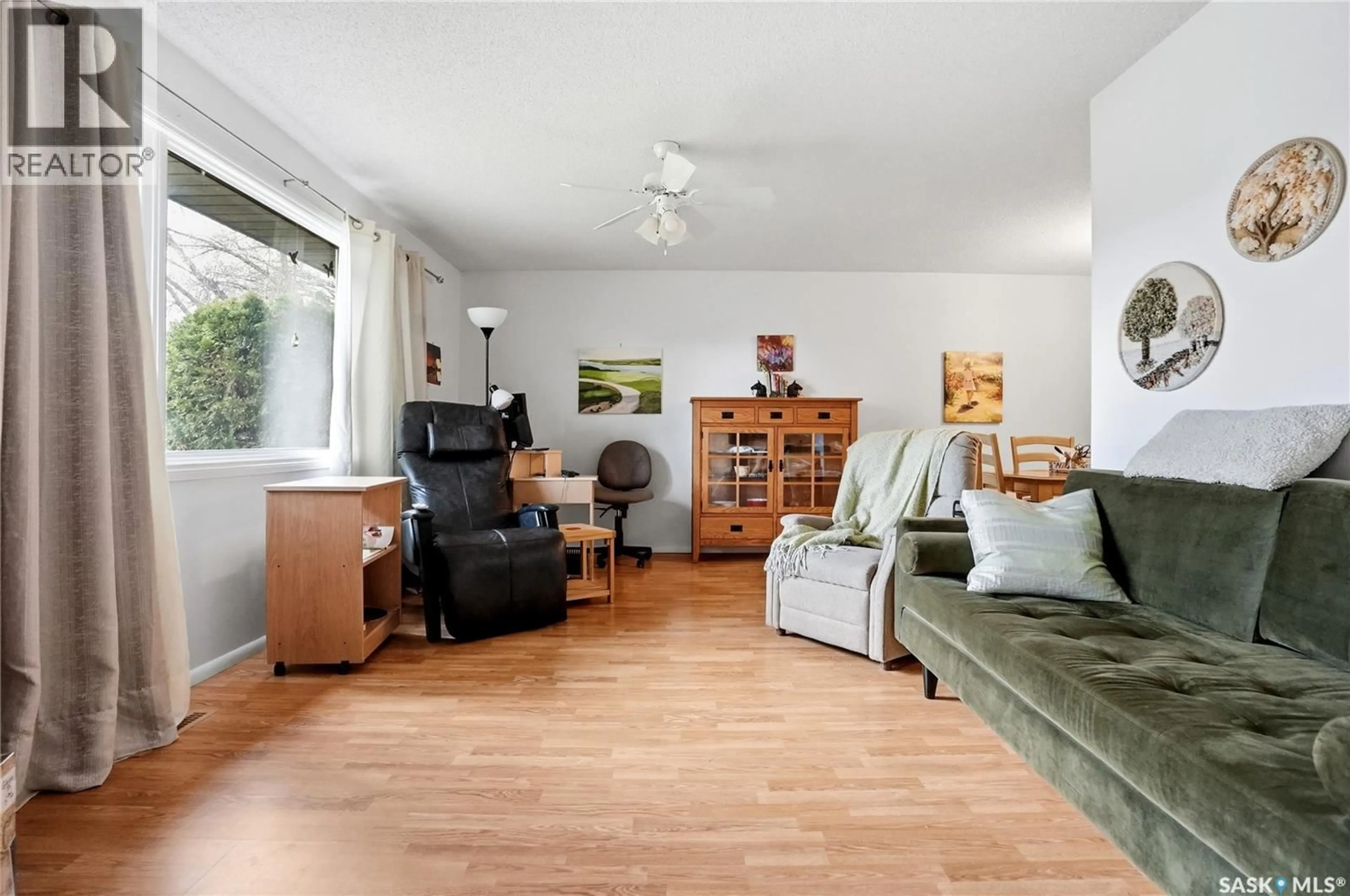 Living room with furniture, wood/laminate floor for 2362 EASTHILL, Saskatoon Saskatchewan S7J3E5
