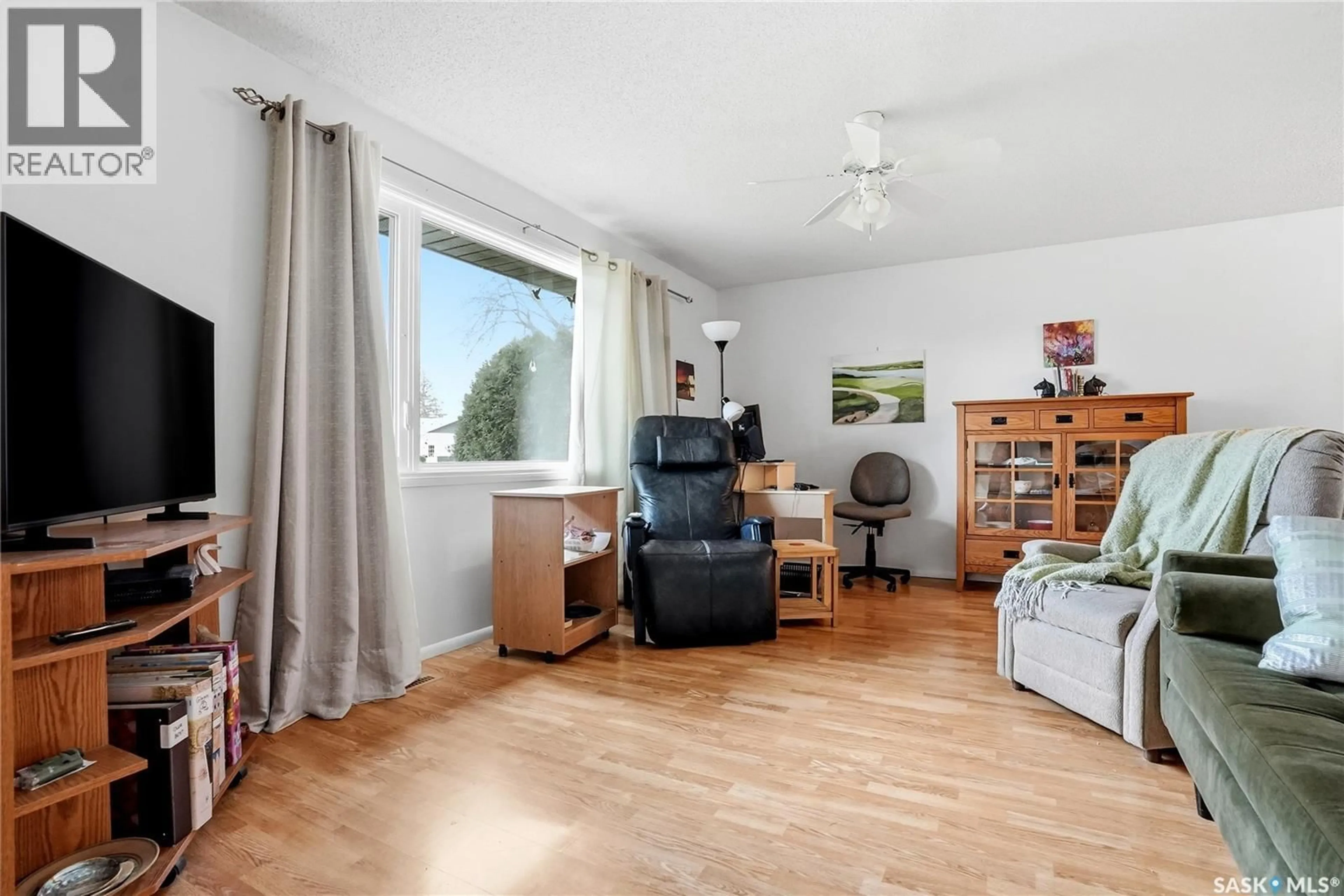 Living room with furniture, wood/laminate floor for 2362 EASTHILL, Saskatoon Saskatchewan S7J3E5