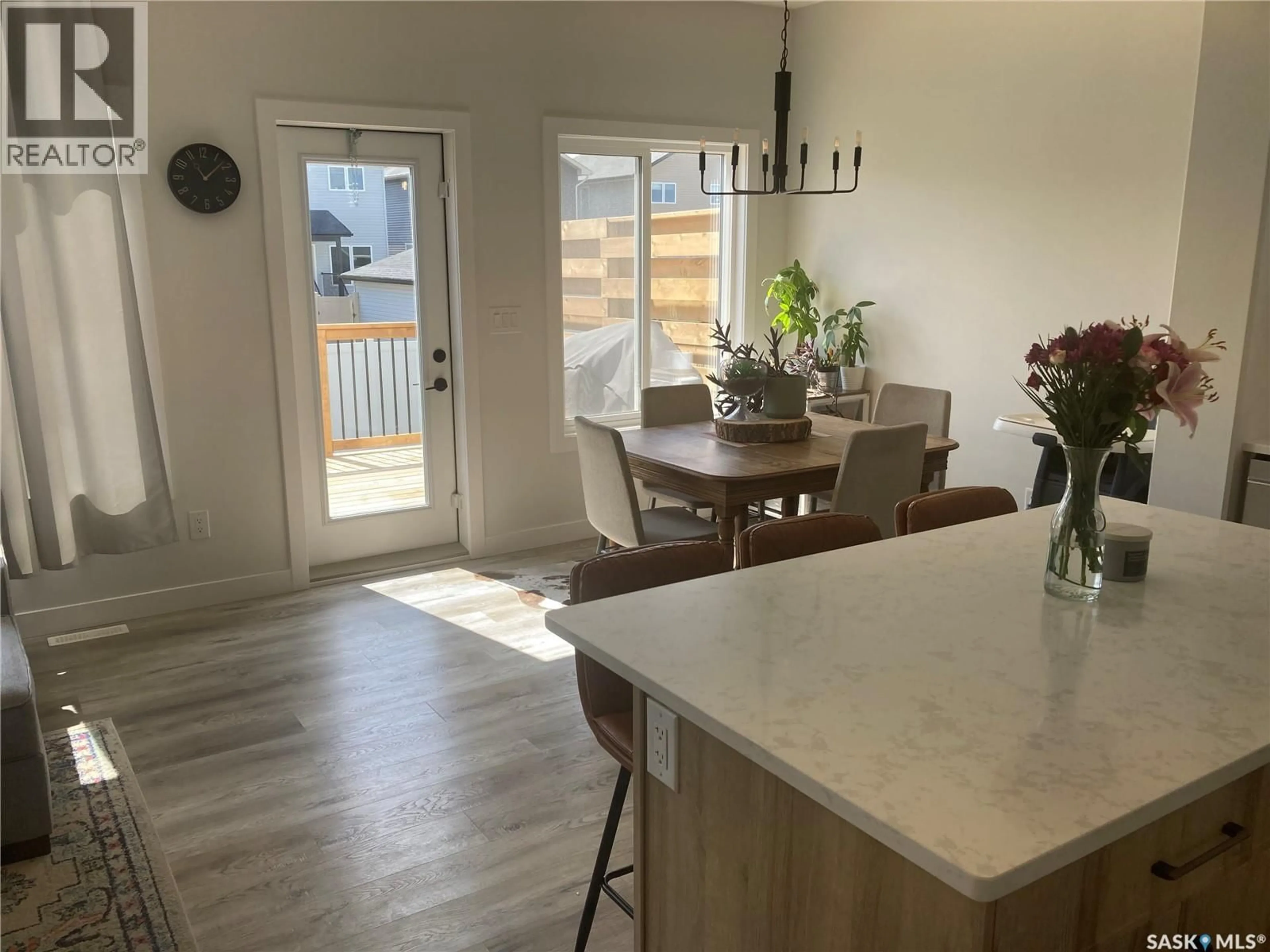 Open concept kitchen, wood/laminate floor for 1312 PARR HILL DRIVE, Martensville Saskatchewan S0K2T1
