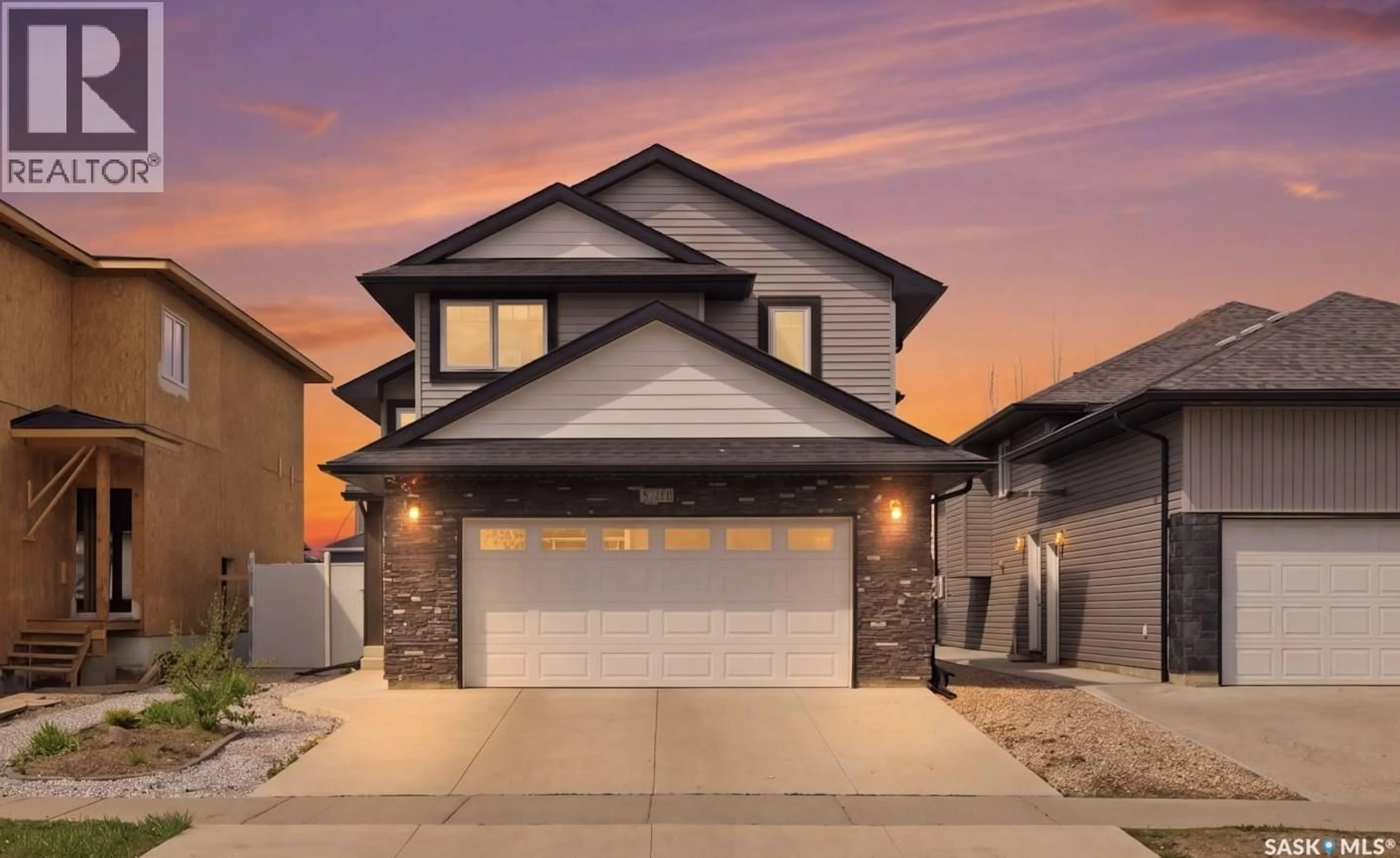 Home with vinyl exterior material, street for 211 BALTZAN BOULEVARD, Saskatoon Saskatchewan S7W0S2