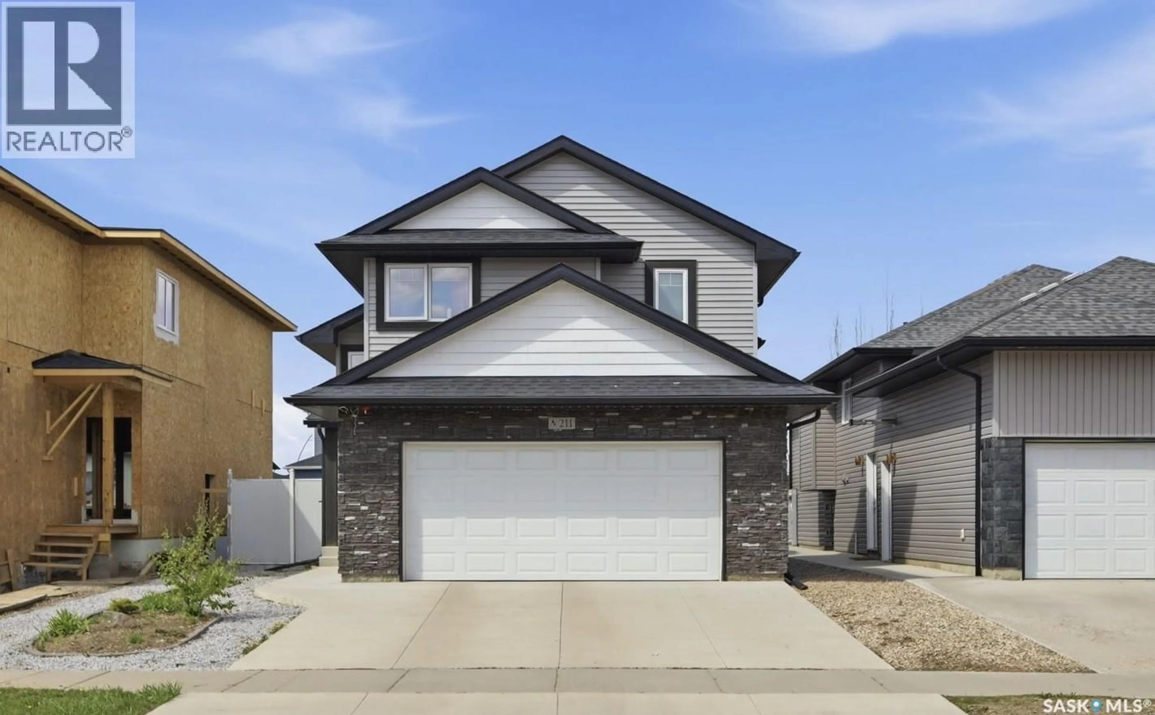 Home with vinyl exterior material, street for 211 BALTZAN BOULEVARD, Saskatoon Saskatchewan S7W0S2