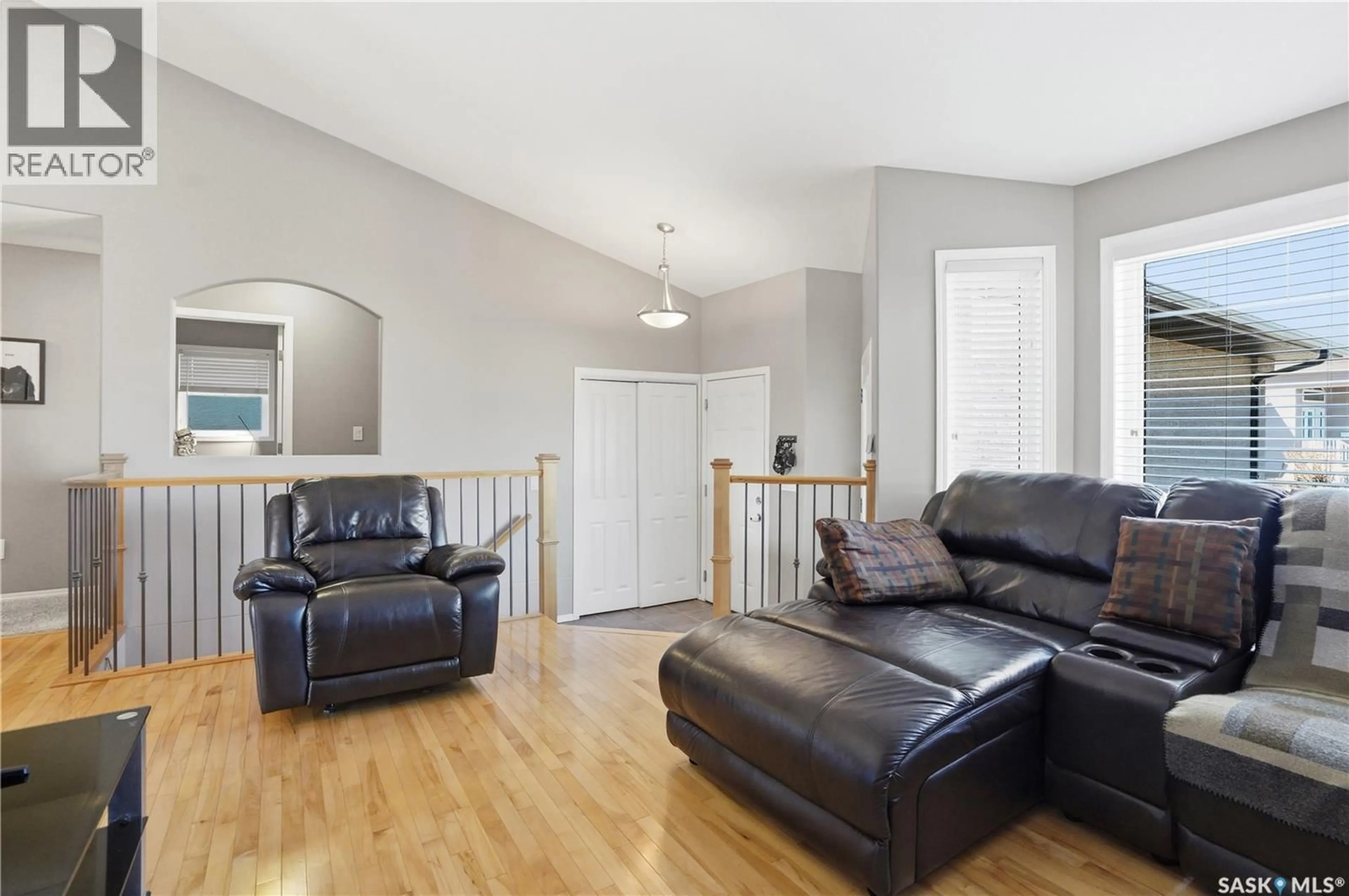 Living room with furniture, wood/laminate floor for 114 FAWCETT CRESCENT, Saskatoon Saskatchewan S7T0G1