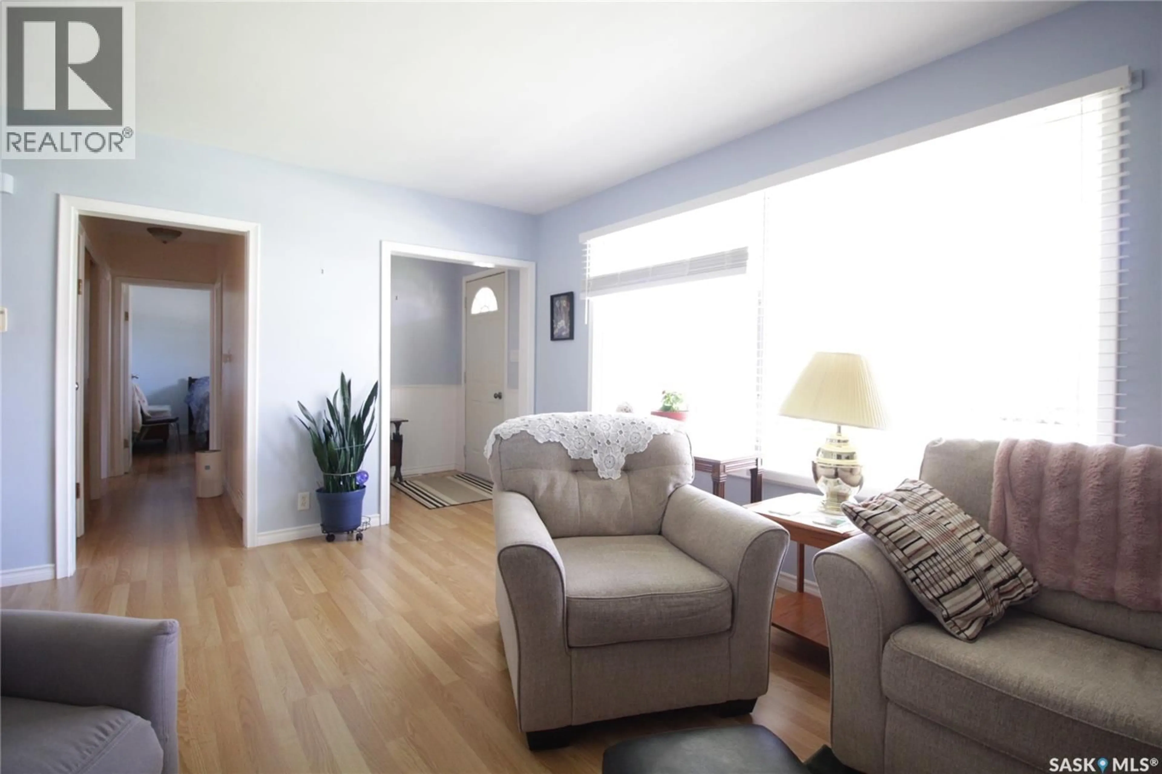 Living room with furniture, wood/laminate floor for 1208 MARK AVENUE, Moosomin Saskatchewan S0G3N0